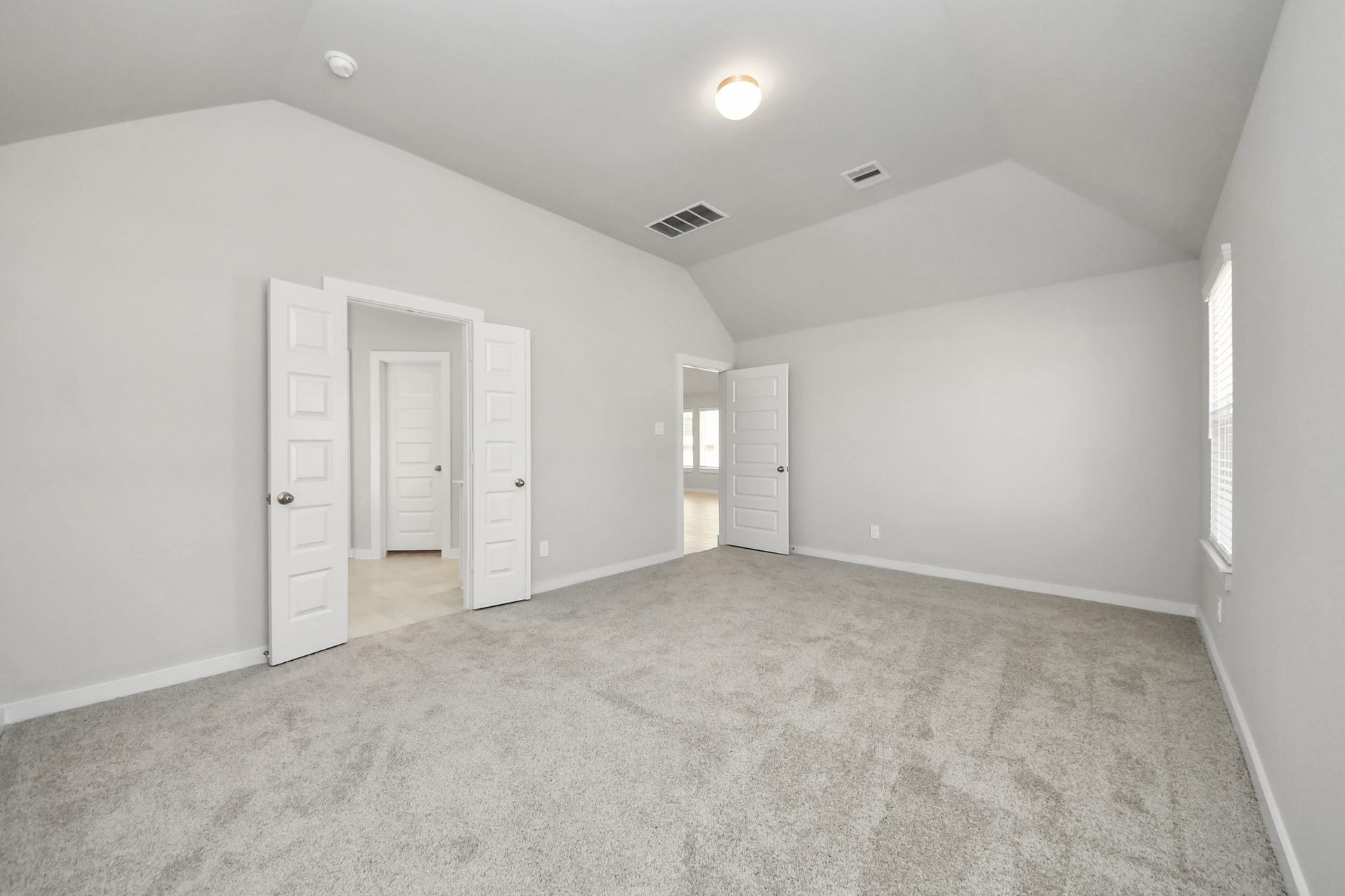 11023 Hosta Stream Drive, Houston, TX 77044 Come and unwind after a long day in this magnificent primary suite! This spacious room features plush carpet, warm paint, high ceilings and large windows with privacy blinds. Sample photo of completed home with similar floor plan. Actual colors and selections may vary.