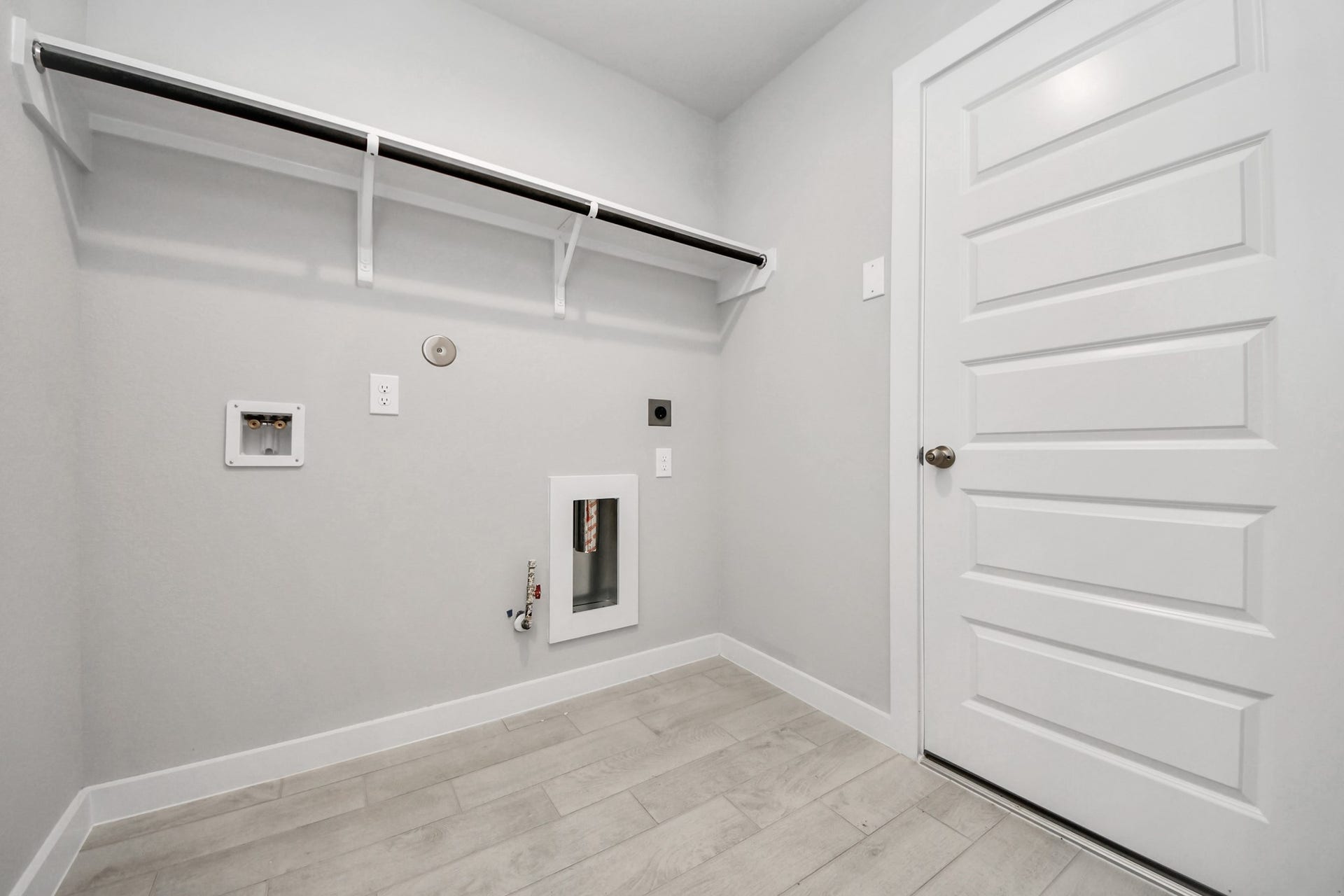 11023 Hosta Stream Drive, Houston, TX 77044 A perfect blend of functionality and comfort. Capture the essence of easy living with a first-floor laundry room, thoughtfully equipped with shelving for effortless organization. Both electric and gas connections available. Sample photo of completed home with similar floor plan. Actual colors and selections may vary.