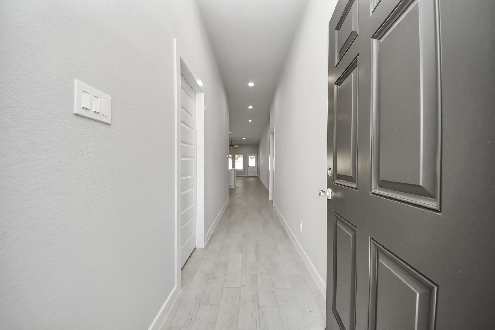 11023 Hosta Stream Drive, Houston, TX 77044 As you step into the threshold of this luxurious home, you'll soon be welcomed by an elegant glass door (to be installed). Inside, soaring ceilings amplify the spaciousness, while the refined wood-look tile flooring and oversized baseboards exude sophistication and charm. Sample photo of completed home with similar floor plan. Actual colors and selections may vary.