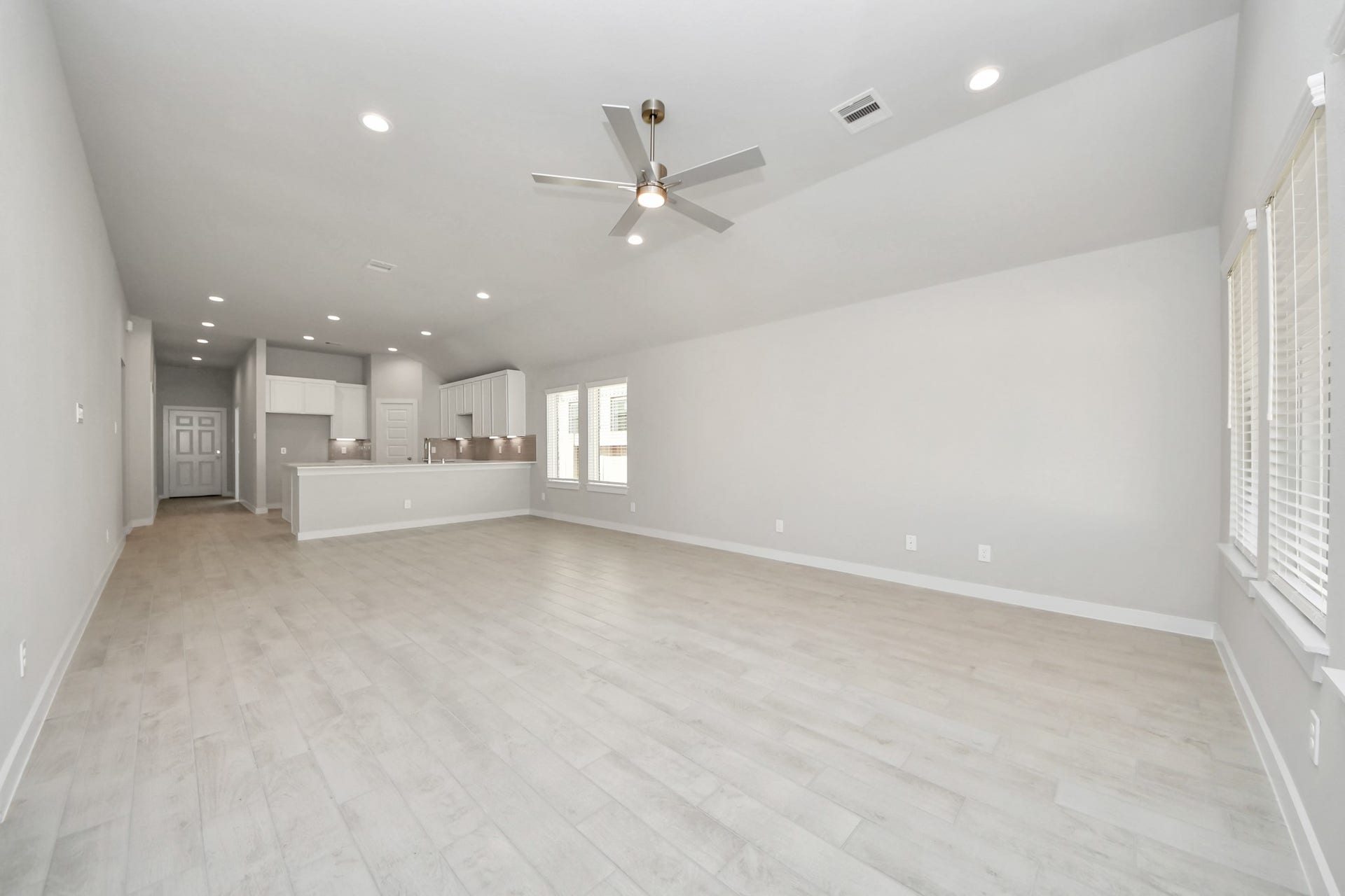 11023 Hosta Stream Drive, Houston, TX 77044 Gather the family and guests together in your lovely living room! Featuring soaring high ceilings, recessed lighting, ceiling fan, custom paint, gorgeous floors, and large windows that provide plenty of natural lighting throughout the day. Sample photo of completed home with similar floor plan. Actual colors and selections may vary.