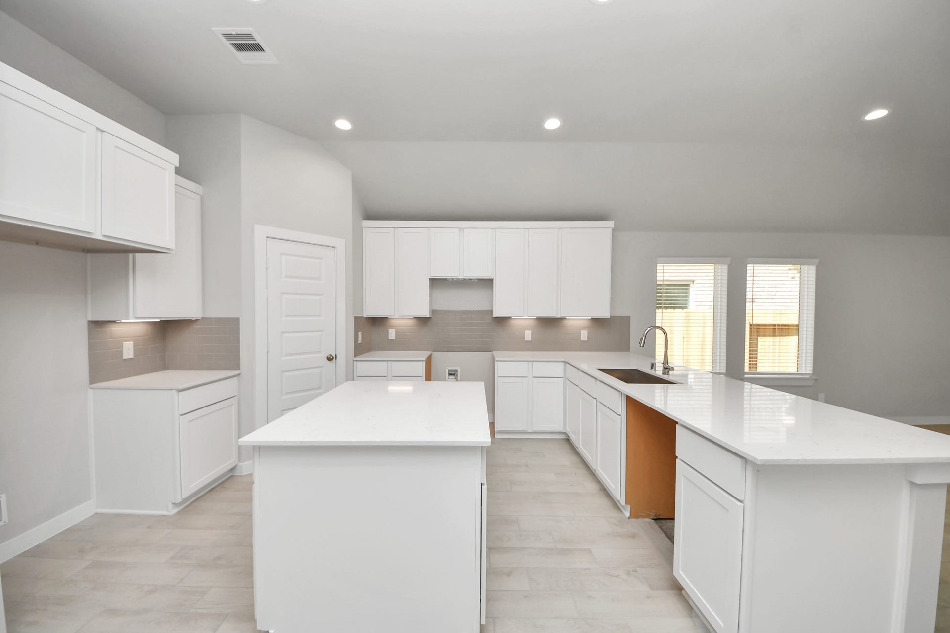 11023 Hosta Stream Drive, Houston, TX 77044 The kitchen is a culinary haven, featuring granite countertops, a tile backsplash, stainless steel appliances, 42 upper cabinets, and undercabinet lighting. Sample photo of completed home with similar floor plan. Actual colors and selections may vary.
