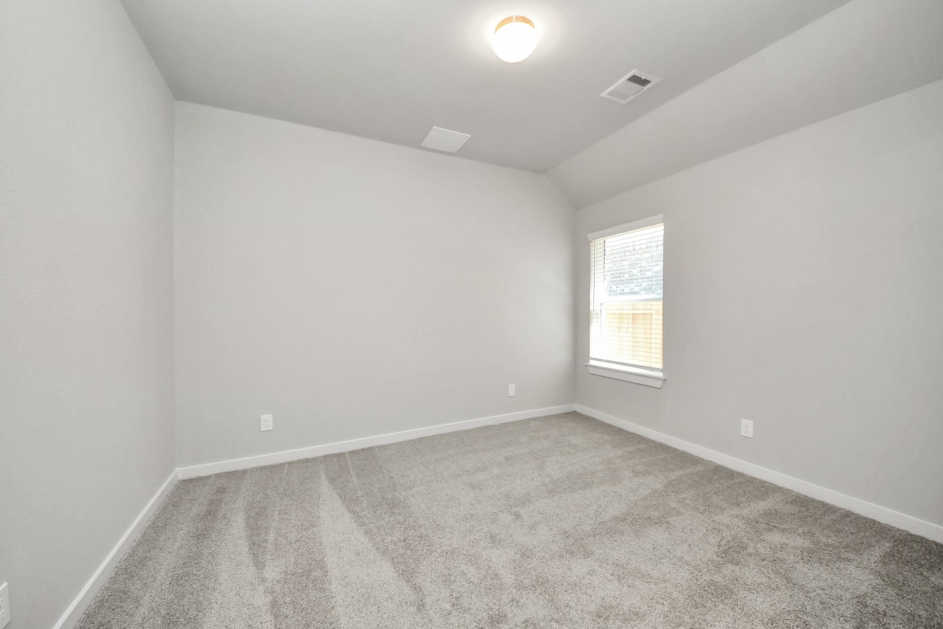 11023 Hosta Stream Drive, Houston, TX 77044 Secondary bedroom features plush carpeting, large windows that let in plenty of natural light, bright paint, and spacious closets. Sample photo of completed home with similar floor plan. Actual colors and selections may vary.