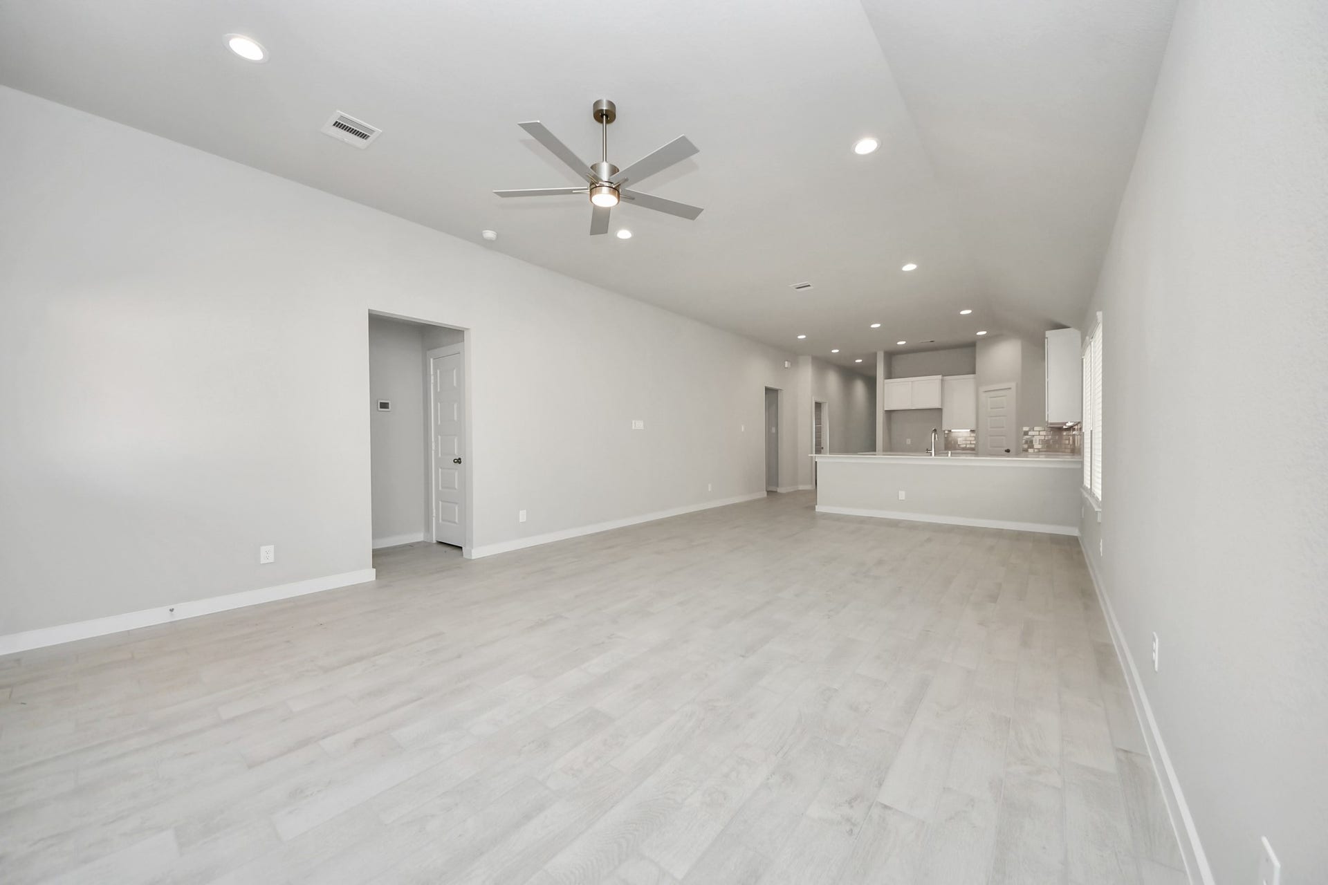 11023 Hosta Stream Drive, Houston, TX 77044 Welcome family and guests to your charming living room! With its high ceilings, recessed lighting, ceiling fan, custom paint, beautiful flooring, and large windows that let in abundant natural light, this room is perfect for gatherings. Sample photo of completed home with similar floor plan. Actual colors and selections may vary.