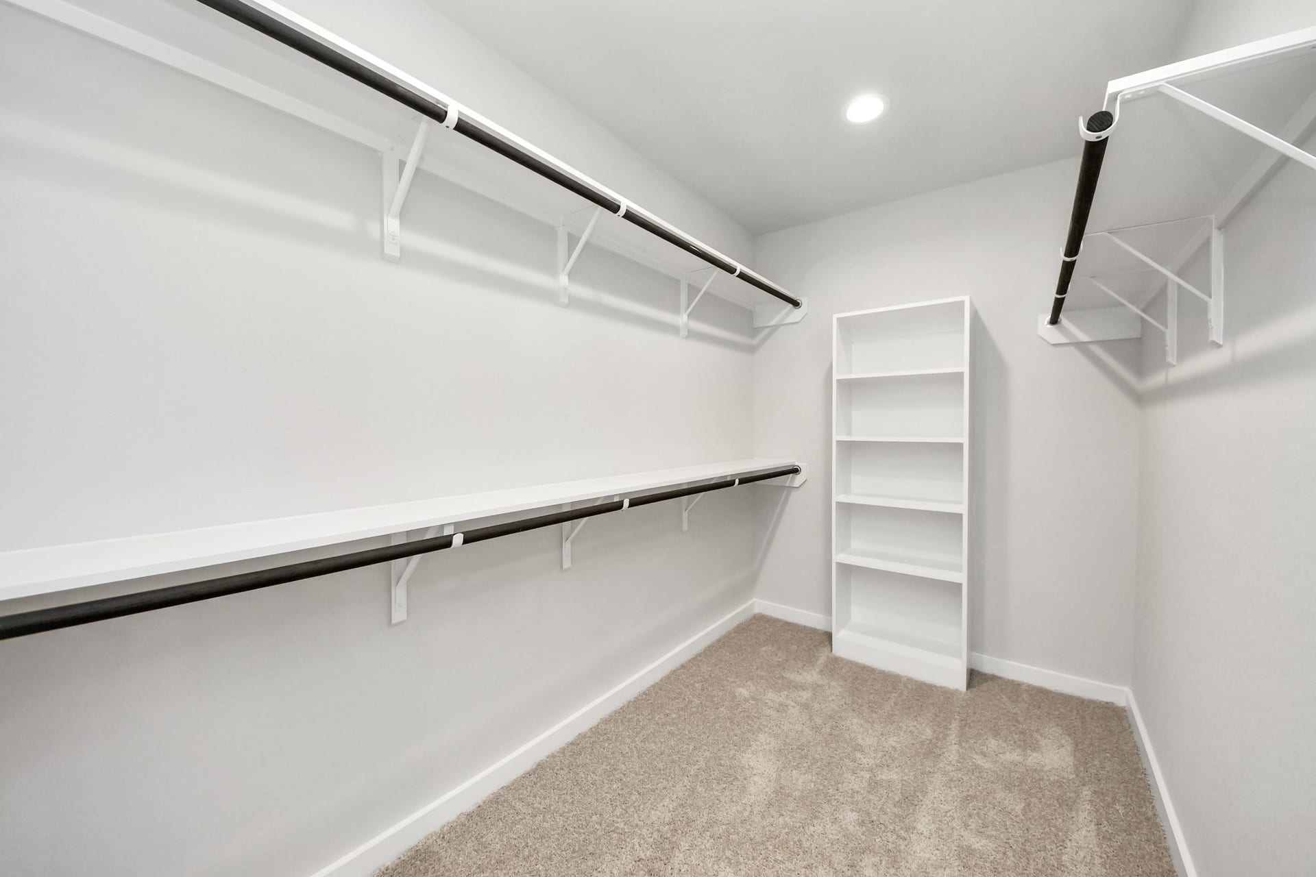 11023 Hosta Stream Drive, Houston, TX 77044 Walk-in closet that epitomizes luxury and practicality. This generously sized space features built-in shelving, offering abundant room for impeccable organization. High ceilings and recessed lighting create a bright and welcoming ambiance. Sample photo of completed home with similar floor plan. Actual colors and selections may vary.