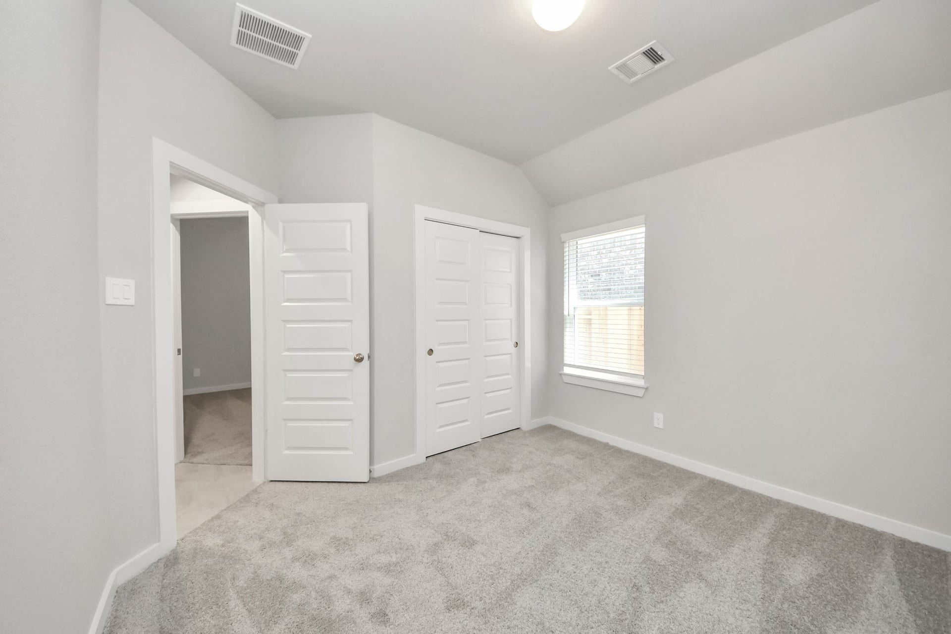 11023 Hosta Stream Drive, Houston, TX 77044 Generously sized secondary bedrooms featuring spacious closets, soft and inviting carpeting underfoot, large windows allowing plenty of natural light, and the added touch of privacy blinds for your personal retreat. Sample photo of completed home with similar floor plan. Actual colors and selections may vary.