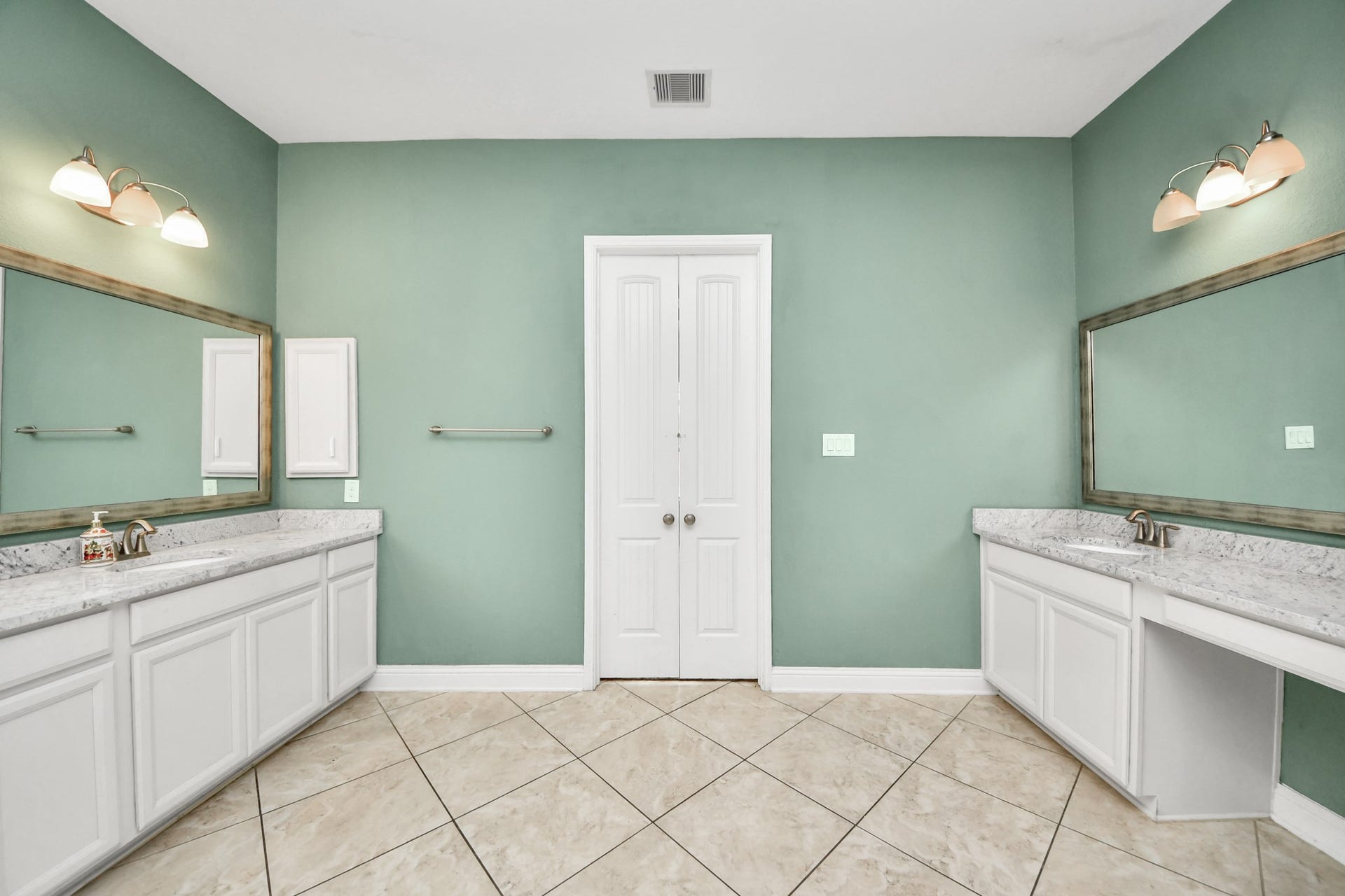 Another view highlighting the separate tub and shower, generous counter space, and functional layout.