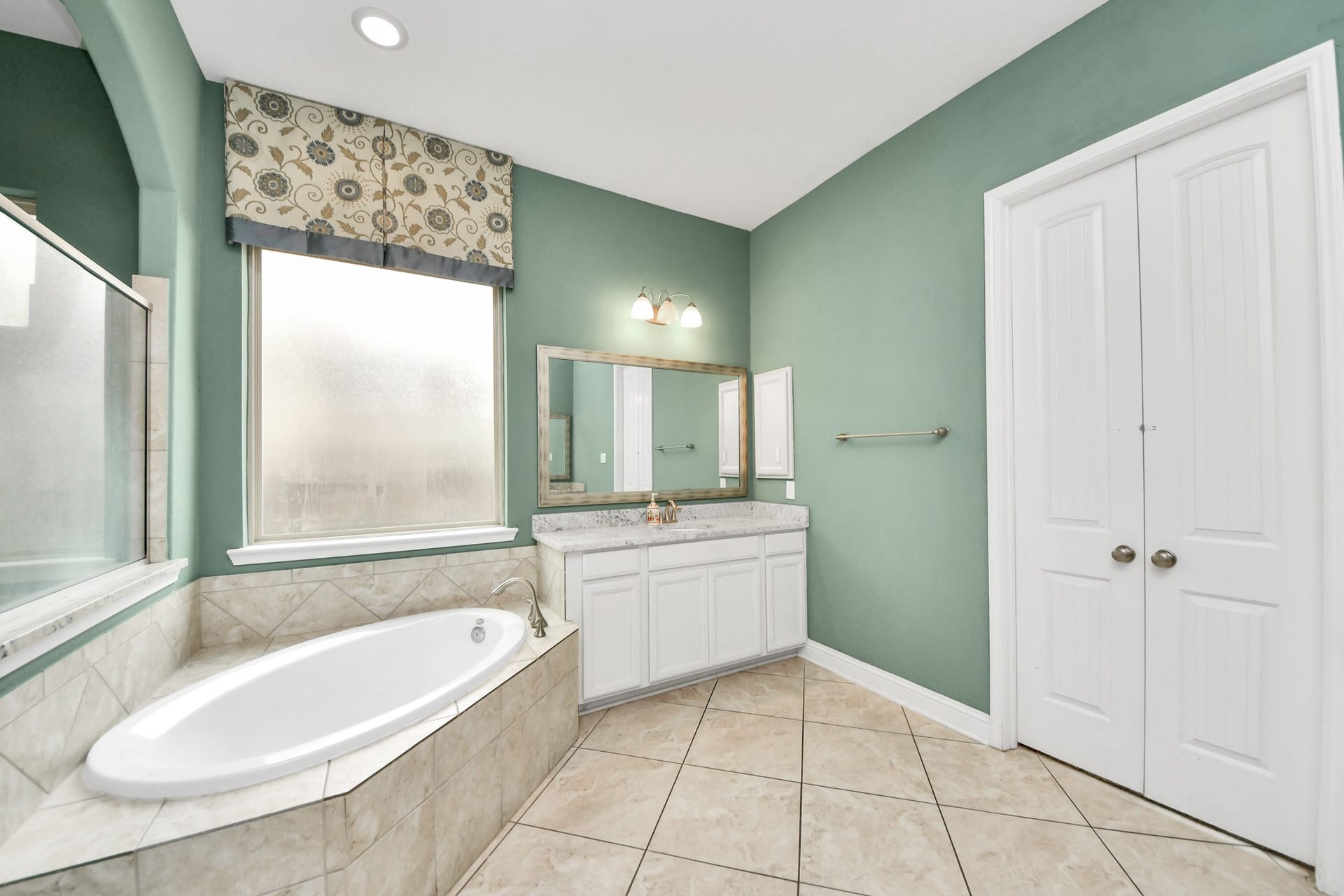 Another view highlighting the separate tub and shower, generous counter space, and functional layout.