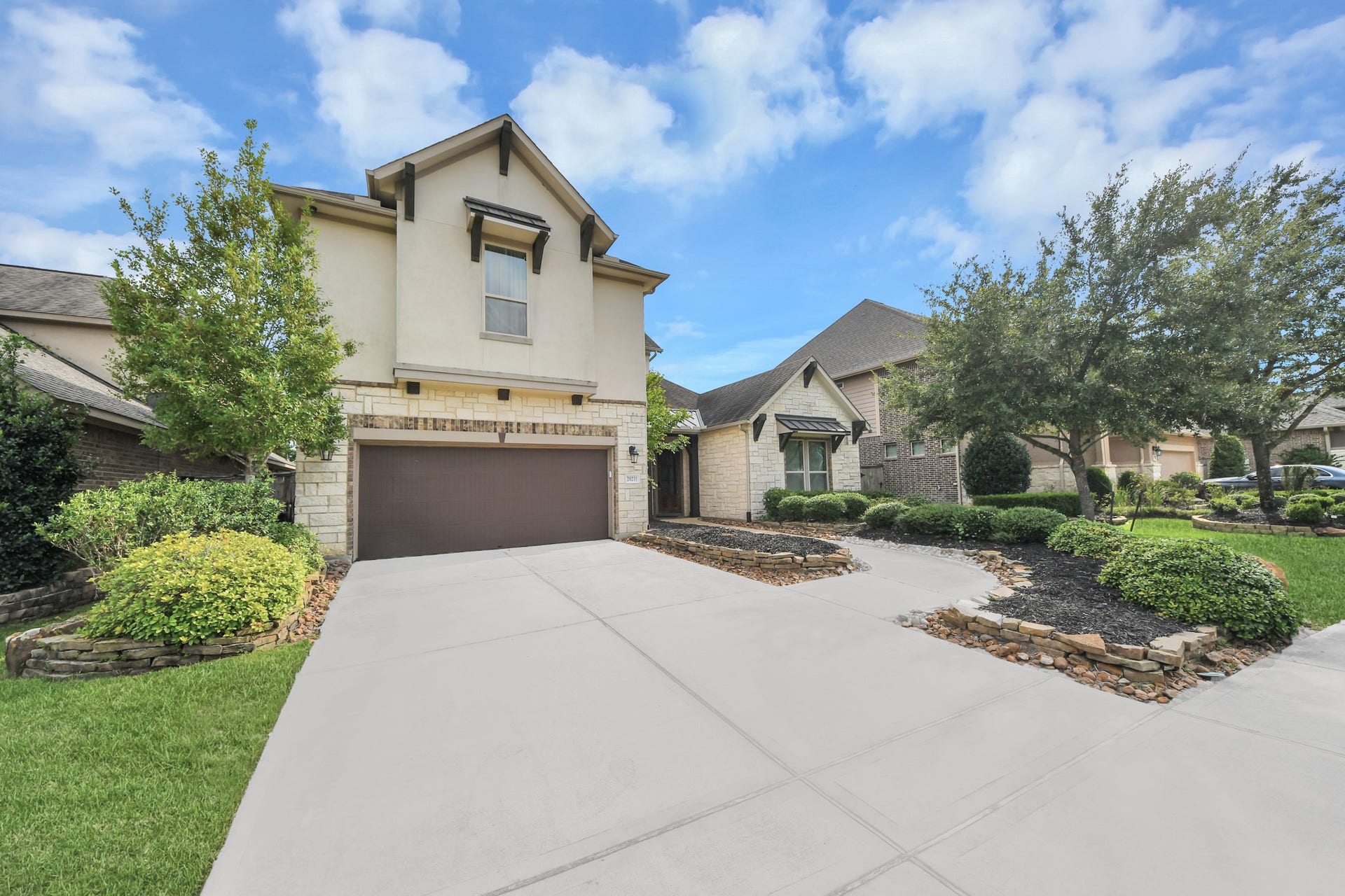 Striking front elevation showcased at twilight with warm exterior lighting and an inviting covered entry.