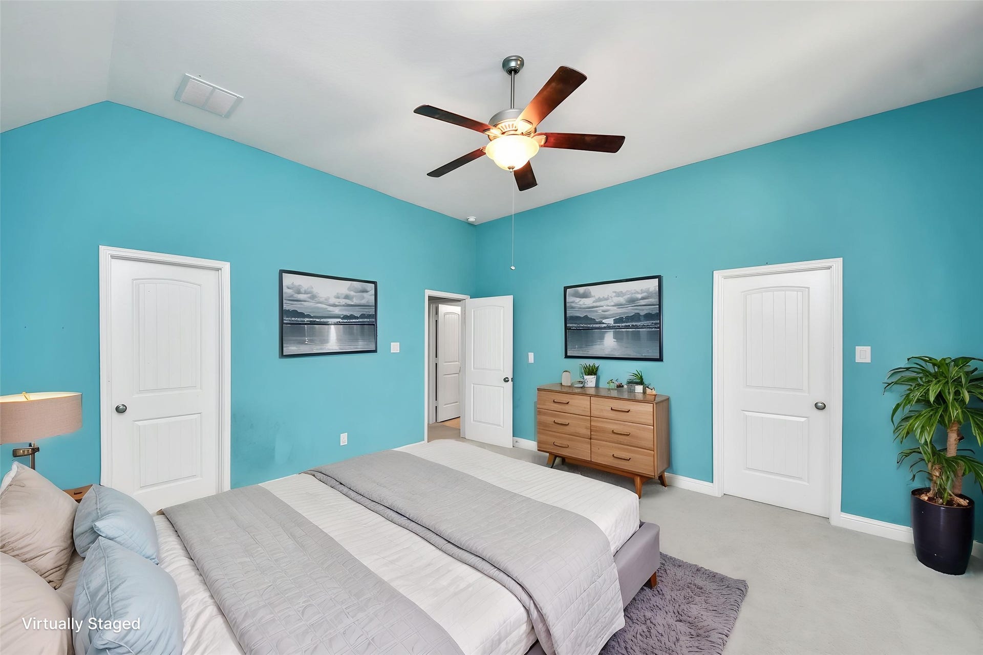 Virtually Staged  Spacious bedroom showcasing the flexible layout and multiple-door configuration for convenient access and storage.