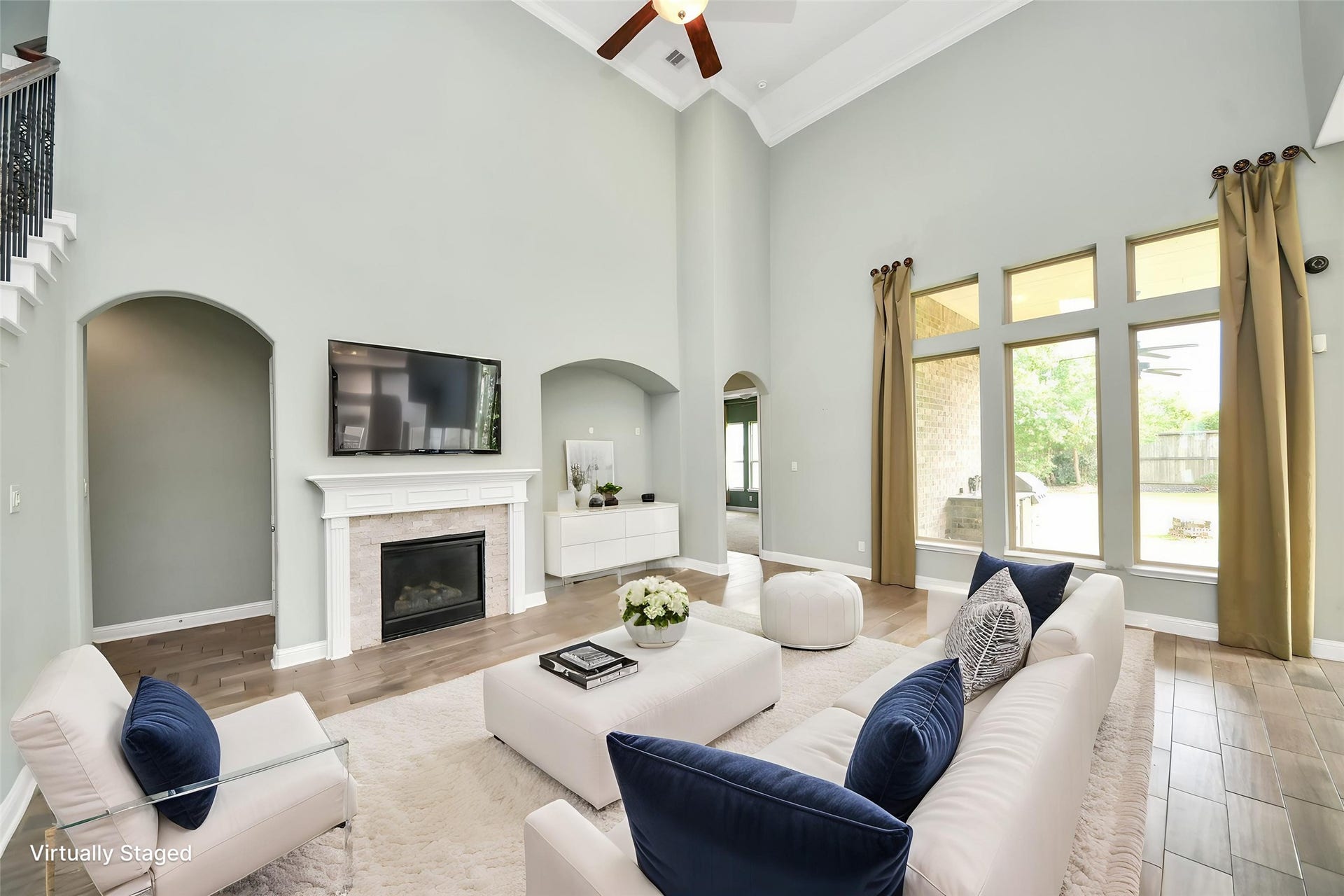 Virtually Staged  Soaring ceilings, fireplace, oversized windows, and virtual staging showcase the impressive main living area.