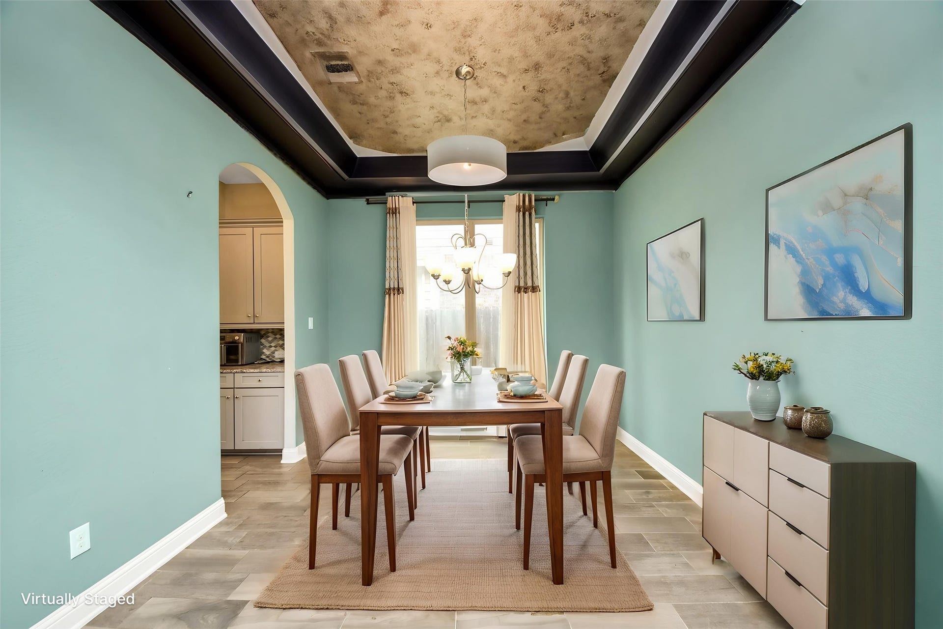 Virtually Staged  Formal dining room with dramatic tray ceiling, architectural detailing, and virtual staging for entertaining.