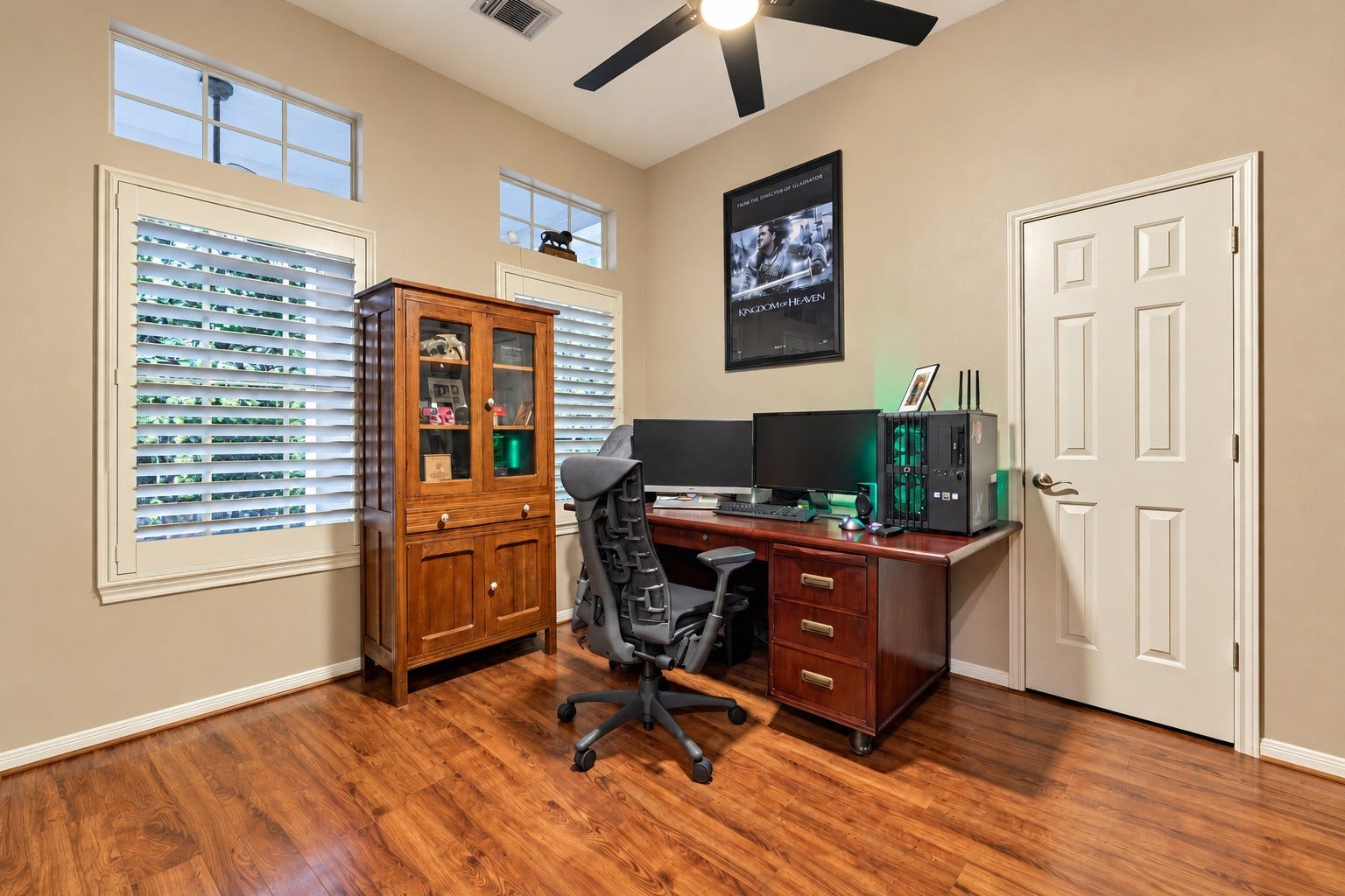 119 N Rambling Ridge Place, The Woodlands, TX 77385 To the left of the foyer, a spacious bedroom currently serves as a study, featuring a large closet, plantation shutters, and transom windows that bring in natural light.
