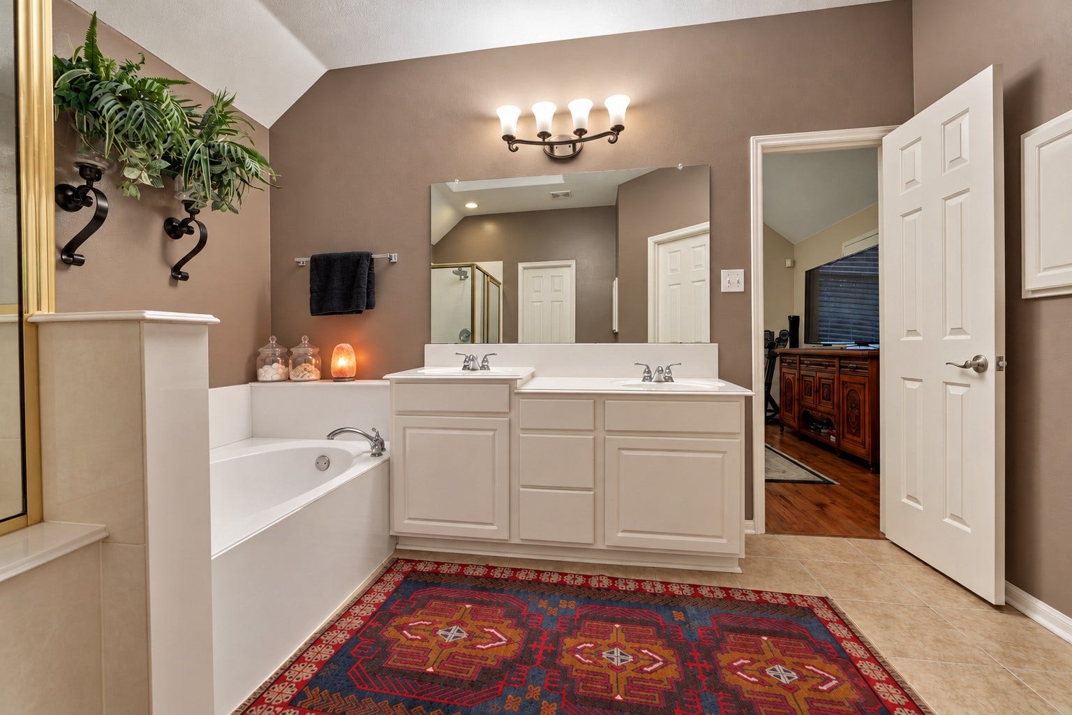 119 N Rambling Ridge Place, The Woodlands, TX 77385 His and hers vanities provide plenty of room for getting ready, giving each person a dedicated space within the primary ensuite.