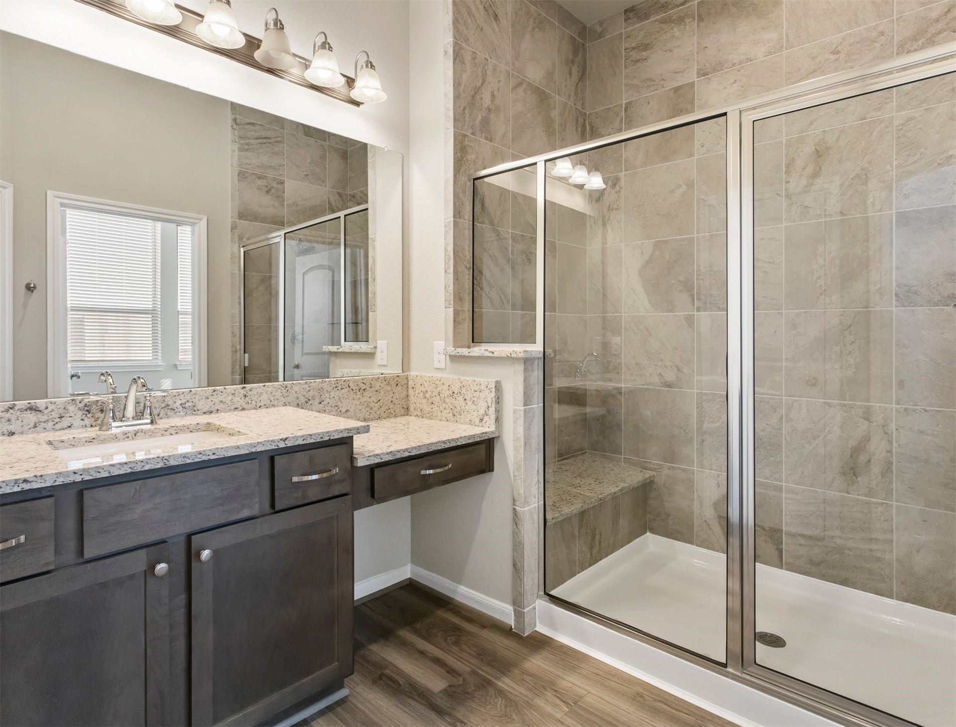 2511 Bordelon Lane, Missouri City, TX 77459 Primary bathroom features tons of trendy touches including stand up shower with seat, granite counters and large mirror. The perfect place to wash off the long day.