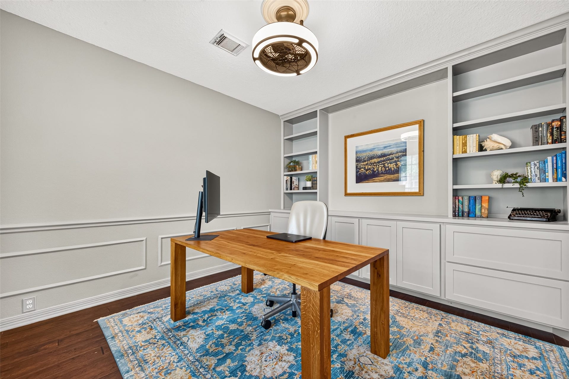 Private study featuring built-in shelving, perfect for productivity and organization.