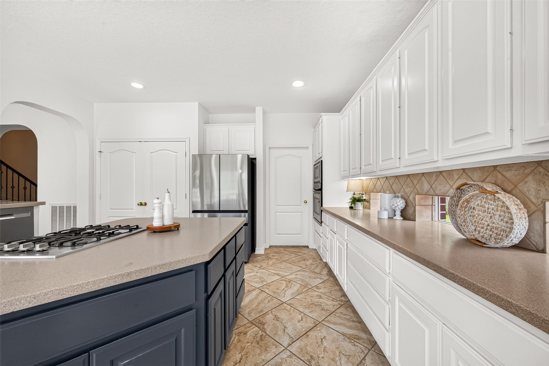 granite island with gas cooktop.