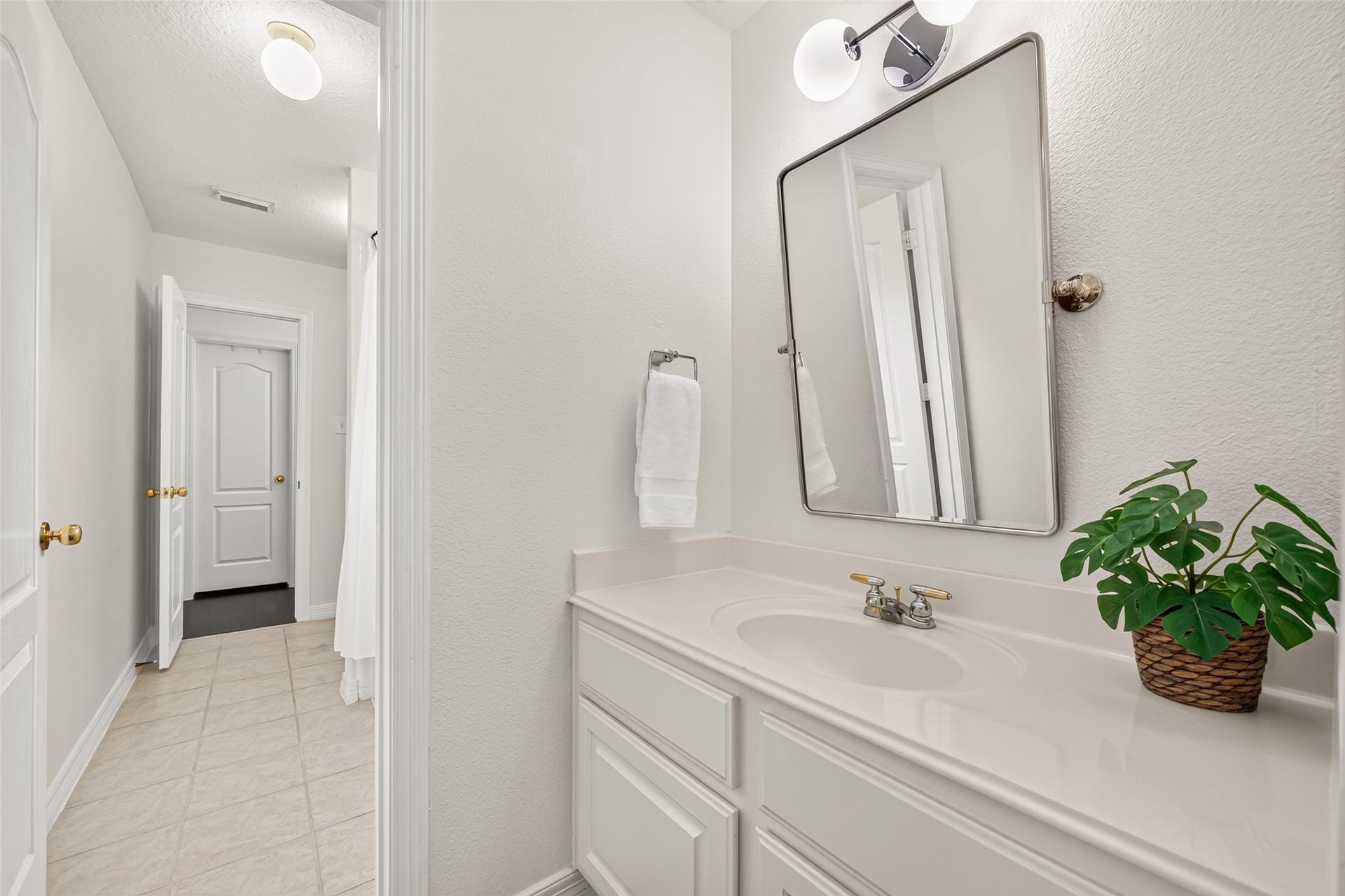 Shared Jack and Jill bath showcasing independent vanity and custom Mirror.