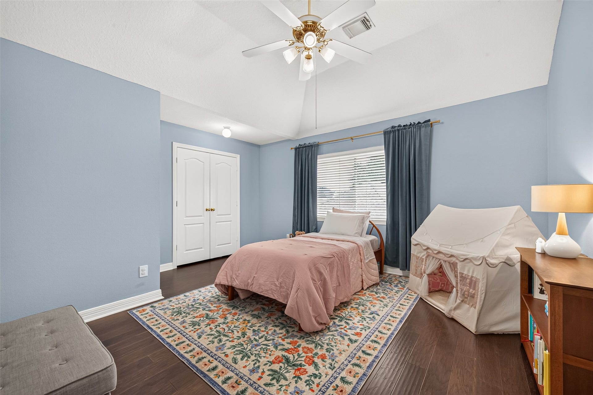 Second floor bedroom with hardwood flooring and natural light.