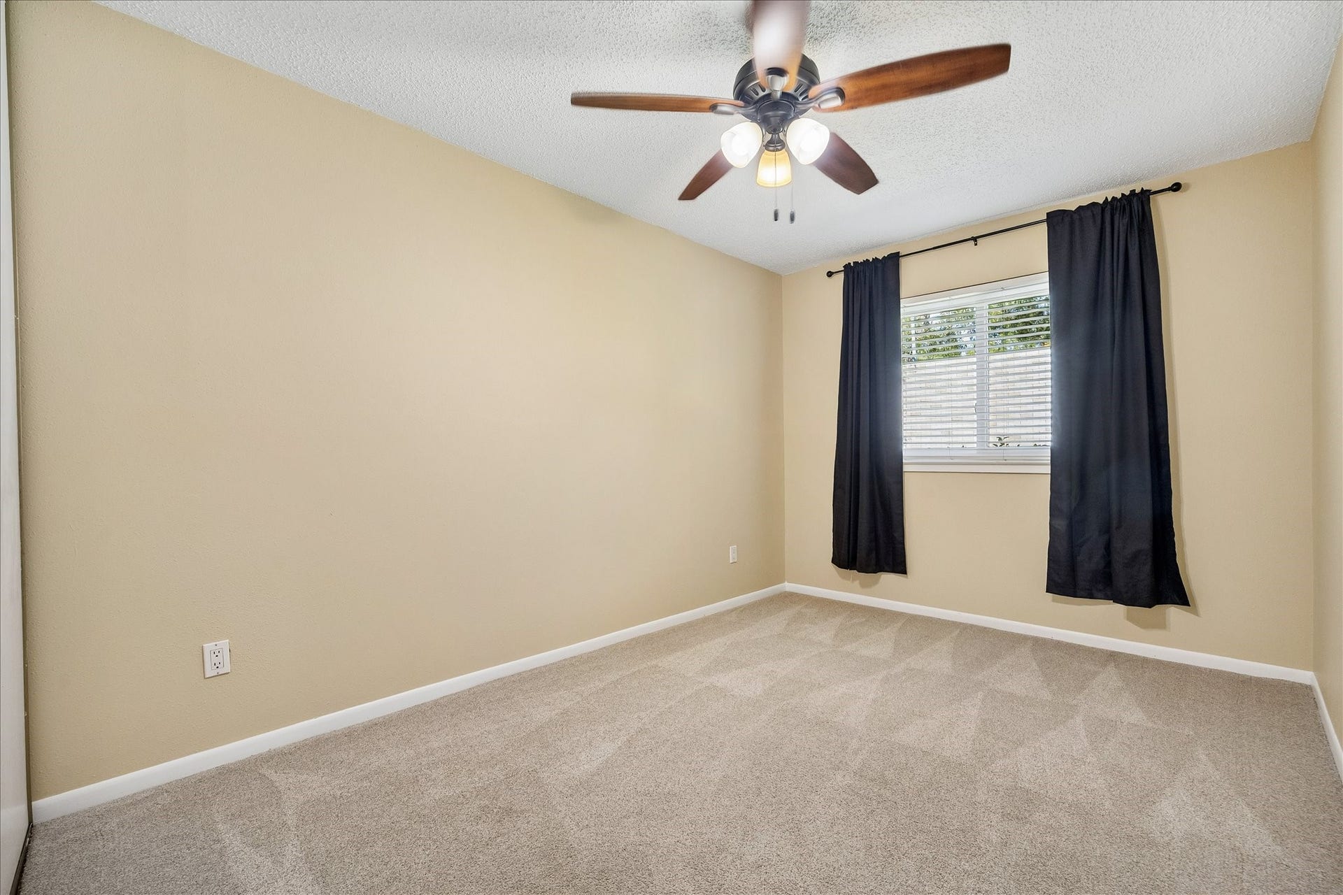 3911 Kitchen Hill Lane, Sugar Land, TX 77479 Settle into this inviting bedroom with soft carpeting, a ceiling fan, and a window dressed with curtains for a comfortable feel.