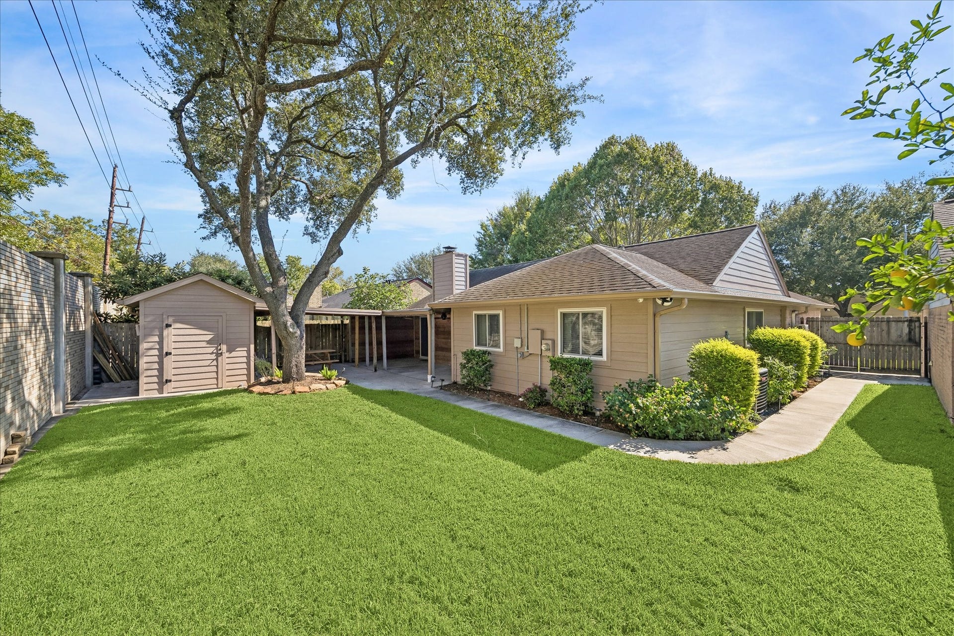 3911 Kitchen Hill Lane, Sugar Land, TX 77479 A generous backyard offers room to play, garden, or simply enjoy the outdoors, with mature trees and a covered patio to complete the setting.
