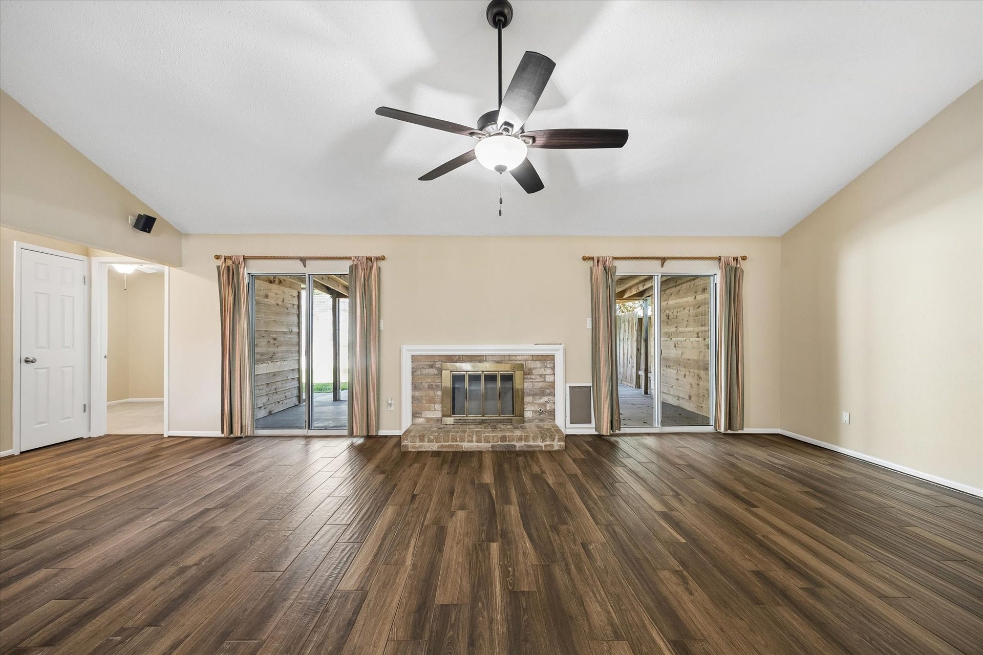 3911 Kitchen Hill Lane, Sugar Land, TX 77479 Gather around the fireplace, enjoy the natural light, and imagine relaxing evenings in this spacious living room with backyard access.