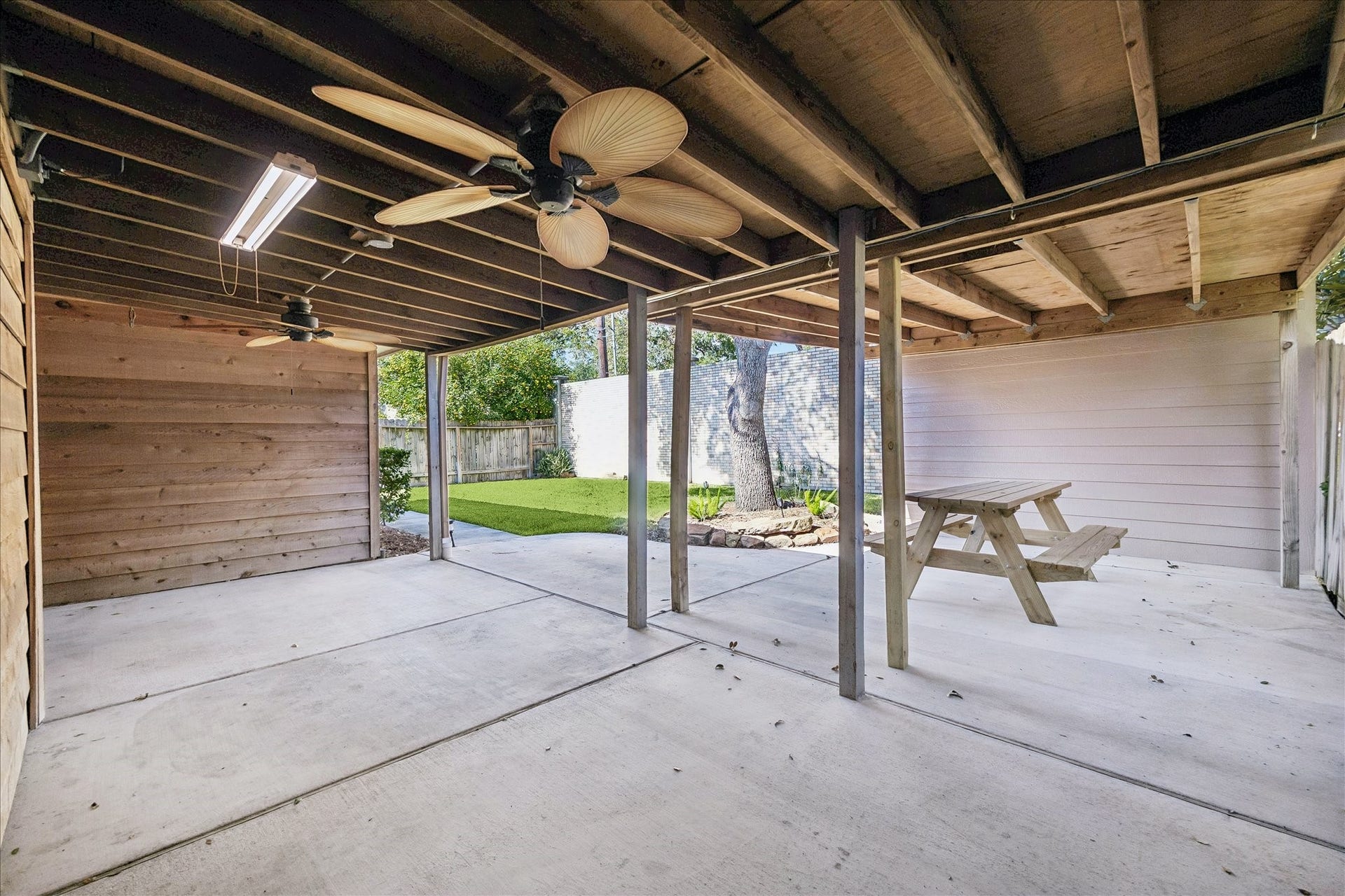 3911 Kitchen Hill Lane, Sugar Land, TX 77479 Make the most of outdoor living with a spacious covered patio featuring overhead lighting, a ceiling fan, and room to gather.