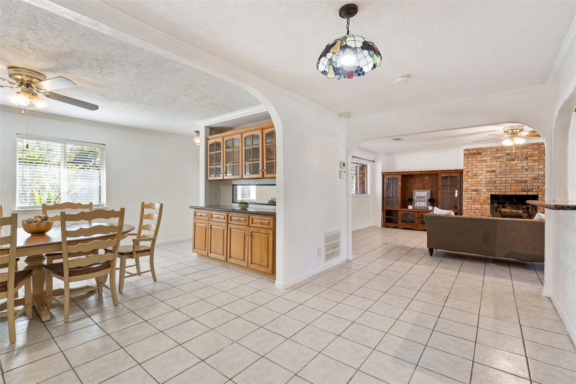An extensive dining room is on the opposite side of the kitchen and offers built in cabinets with glass inserts, and bright neutral paint.*Home was previously furnished. There is currently no furniture in the home.