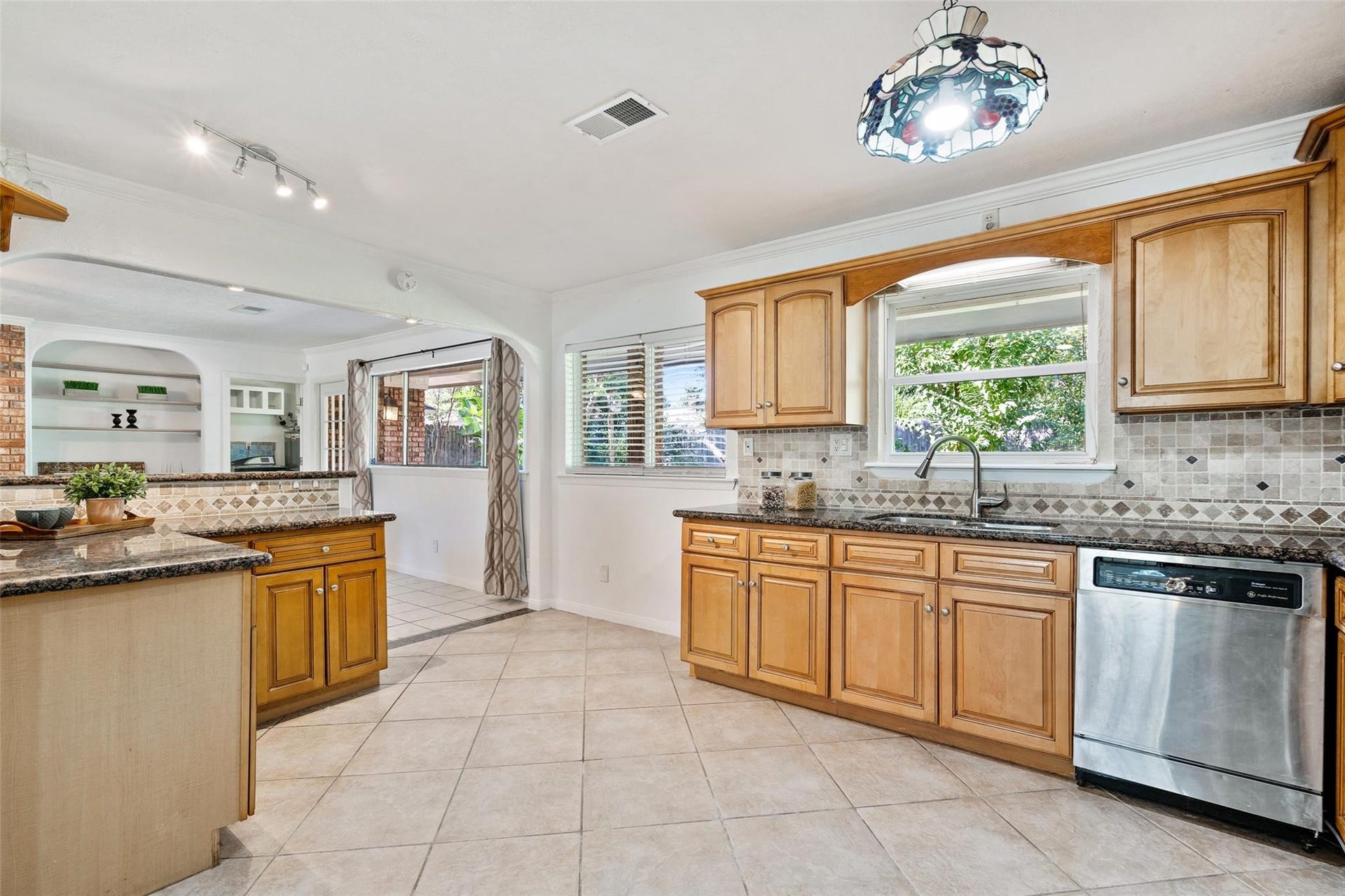 Large windows offer views into the gorgeous backyard! Beautiful tile with diamond pattern design gracefully flow throughout the kitchen.*Home was previously furnished. There is currently no furniture in the home.