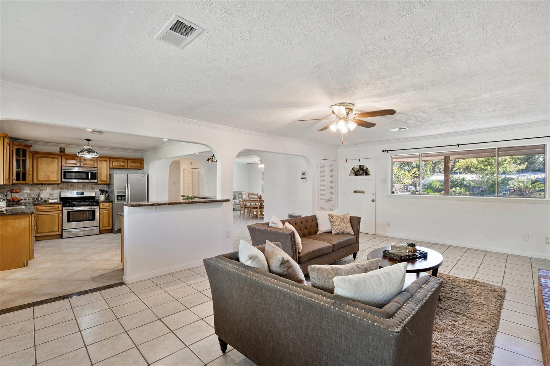Never miss a minute of the action with this open concept kitchen and living design!