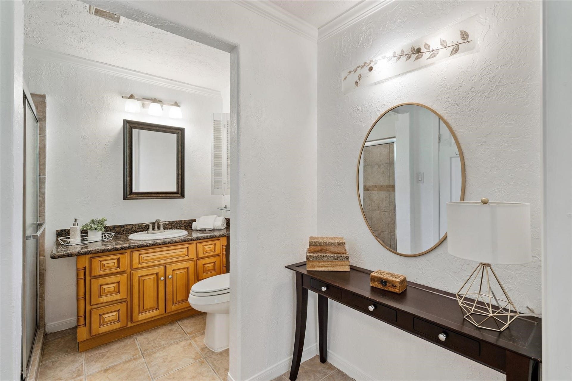 Beautiful primary master bathroom has a small nook perfect for shelving or a vanity! Updated cabinets and shower tile are hallmarks of this great space.*Home was previously furnished. There is currently no furniture in the home