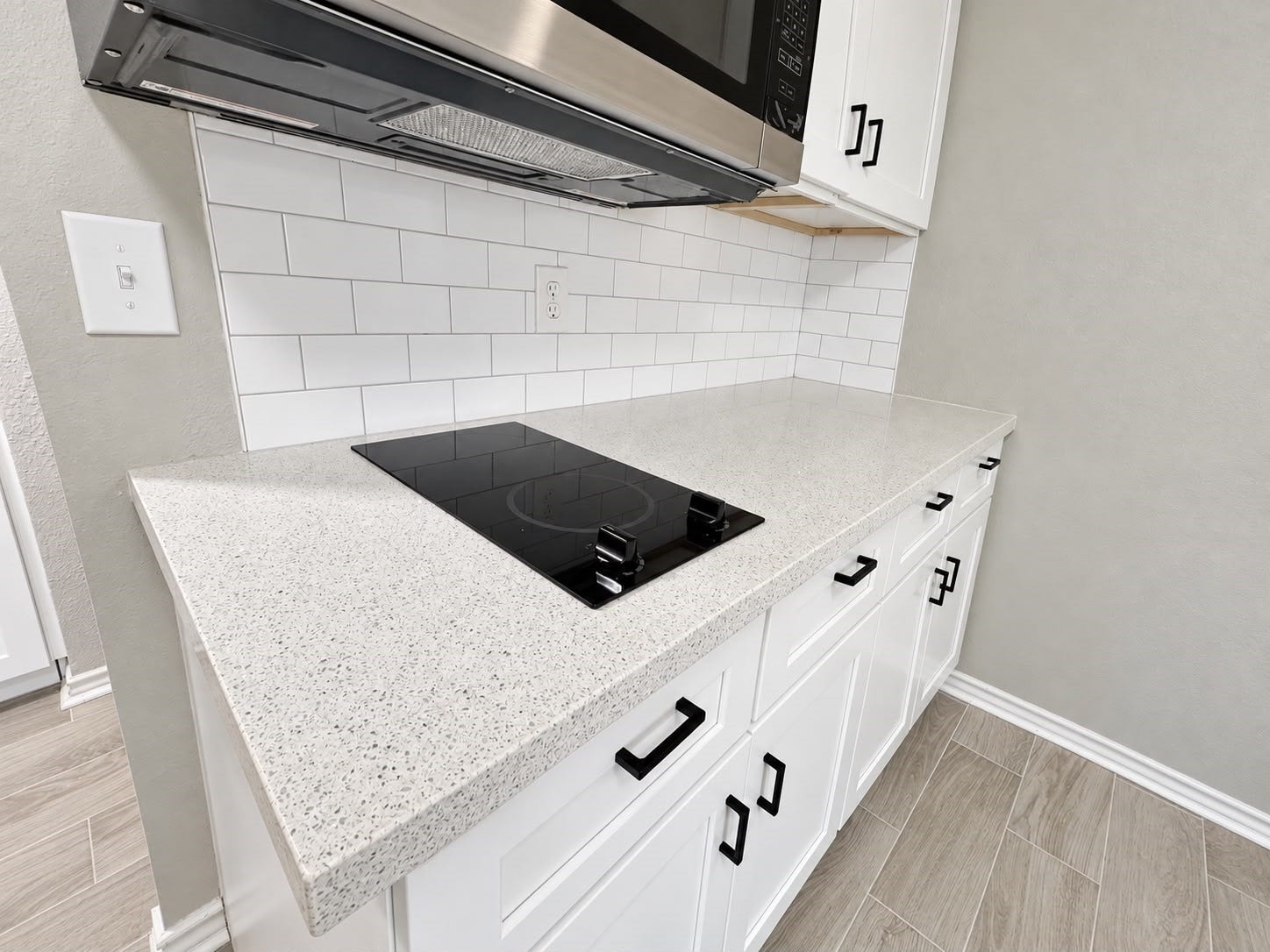 9711 Linkmeadow Lane, #12B, Houston, TX 77025 Kitchenette featuring sleek countertops and white subway tile backsplash.
