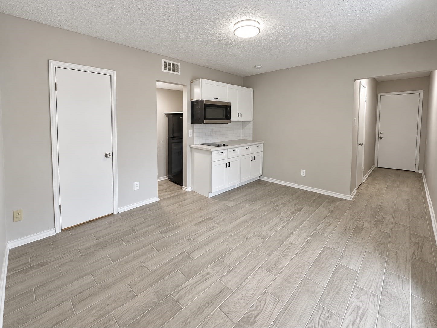 9711 Linkmeadow Lane, #12B, Houston, TX 77025 Open studio layout with kitchenette and entry hallway.