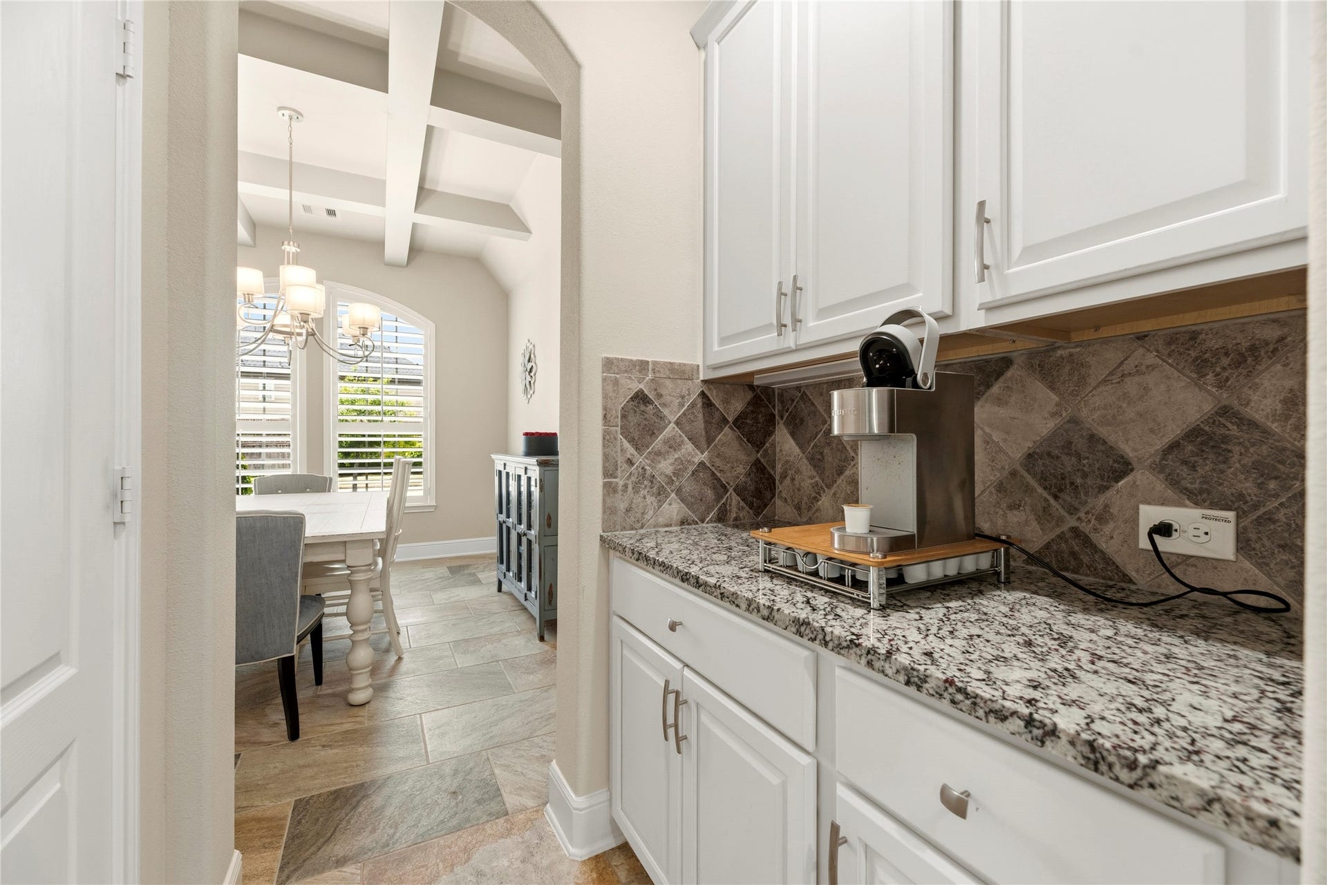 22826 Burton Grove Road, Richmond, TX 77469 Between the kitchen and dining room is this convenient butler's pantry. The pantry is behind the door on the left.