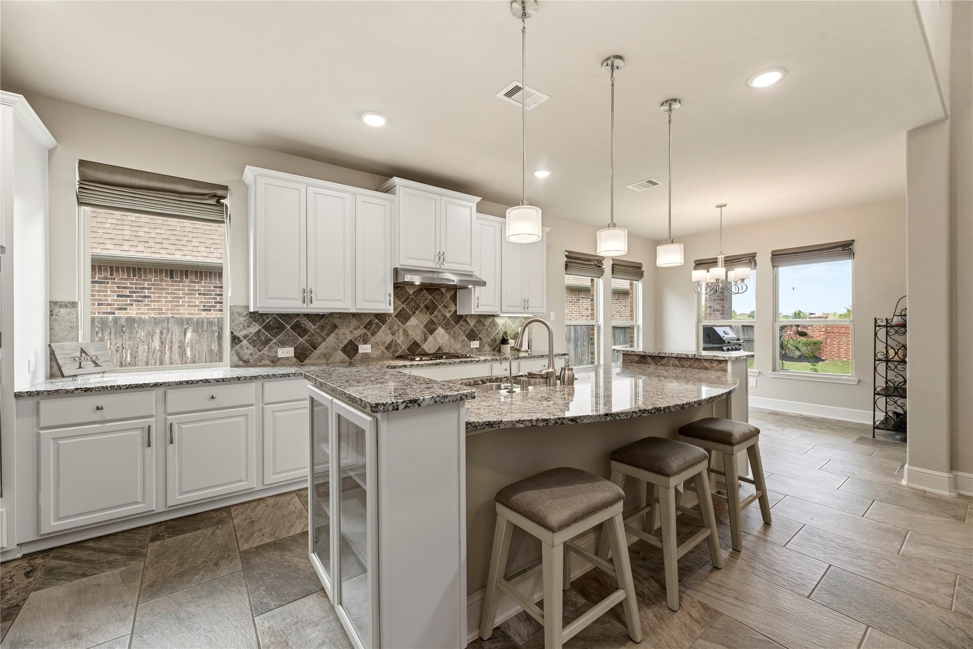 22826 Burton Grove Road, Richmond, TX 77469 This fabulous kitchen features white cabinetry, granite counters and stainless appliances.