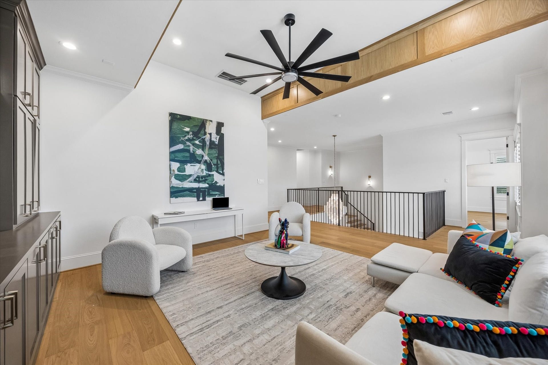 Open to the two story foyer below, the spacious gameroom creates a dedicated second living area with a strong connection to the rest of the home. Wood detailing, wide plank flooring and an open railing carry the homes cohesive design upstairs.
