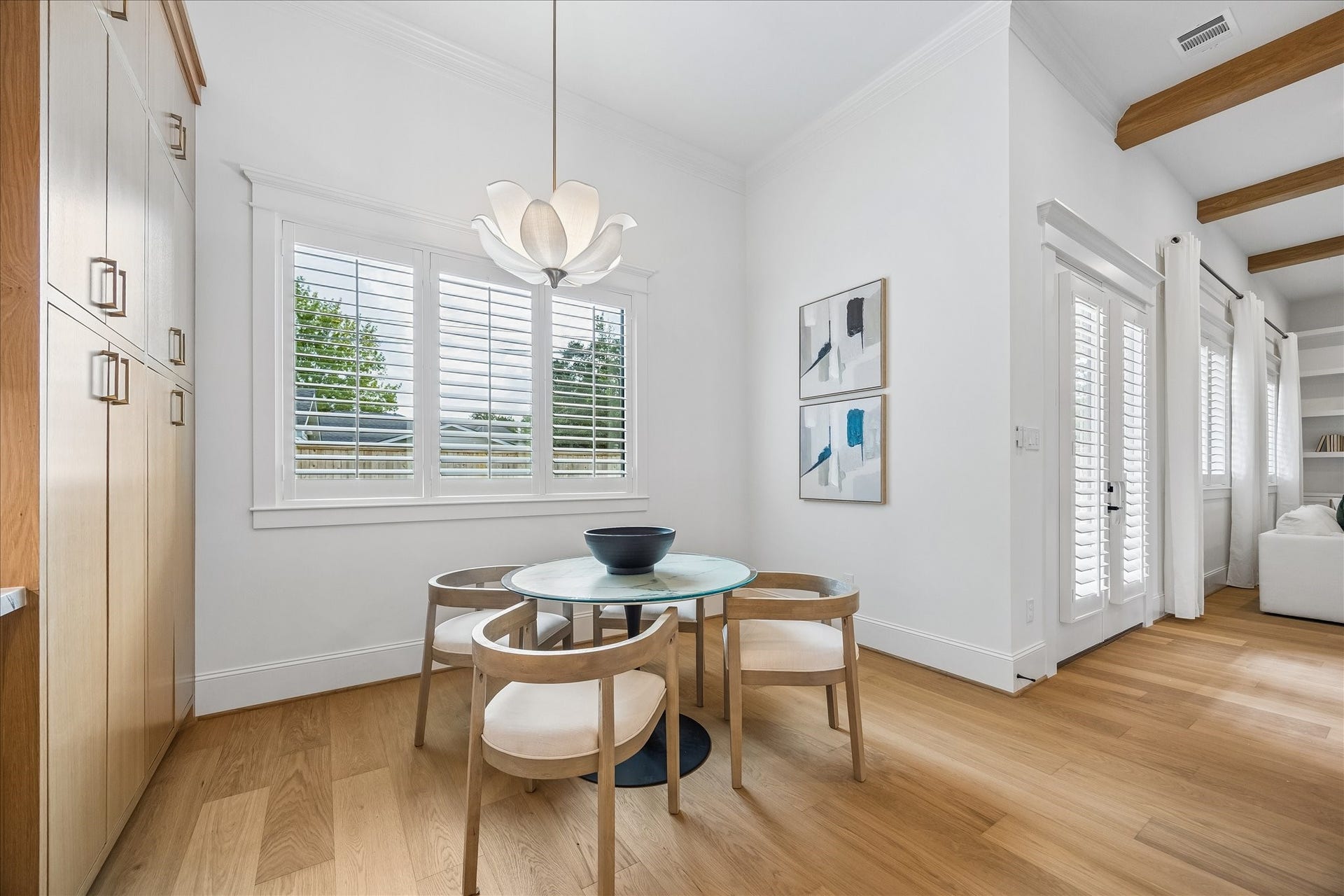 Breakfast nook sits just off the kitchen with plantation shutters bringing in natural light and built in cabinetry nearby for added storage. Its open connection to the kitchen and living area creates an easy setting for casual everyday dining.