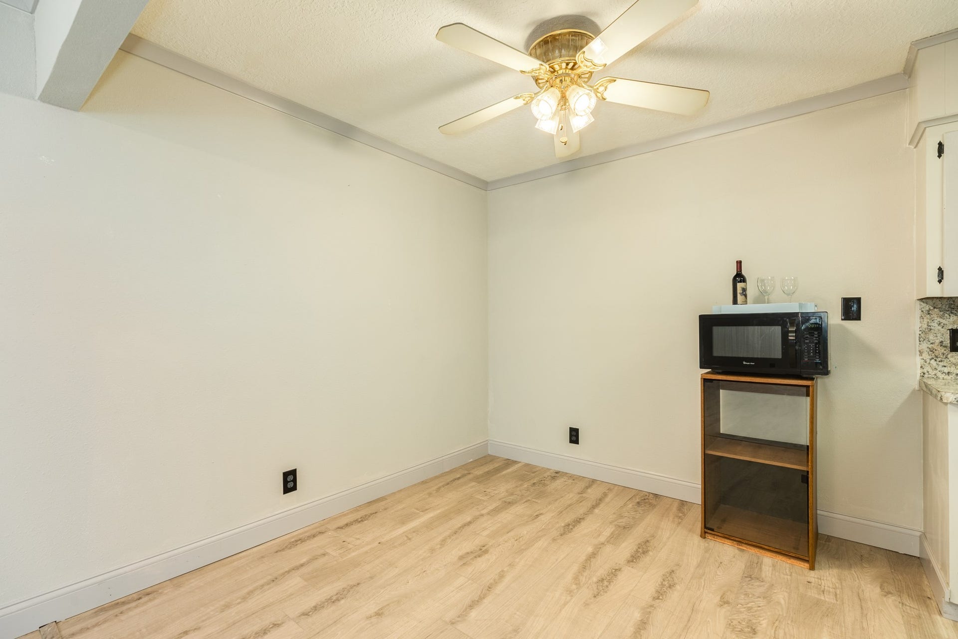 Convenient dining area located just off the kitchen offers an inviting space for everyday meals. Wood-look flooring continues throughout, easy access to the kitchen complement the home's comfortable, connected floor plan.