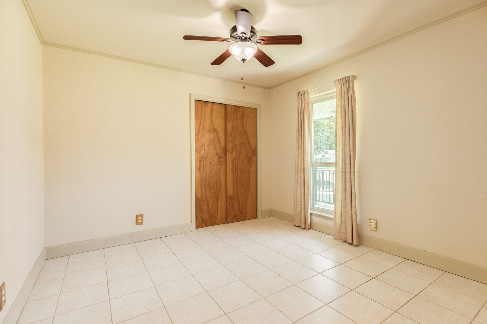Comfortable bedrooms feature easy-care tile flooring, ceiling fans, and windows that provide plenty of natural light. Generously sized rooms offer flexibility for bedroom furniture, guest accommodations, a home office, or hobby space, with closet storage available in select rooms.