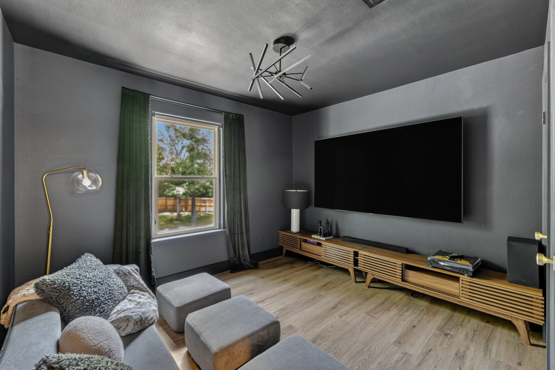 129 N Rainbow Ridge Circle, The Woodlands, TX 77381 Bedroom to a fully transformed media room designed for immersive movie nights and game days alike