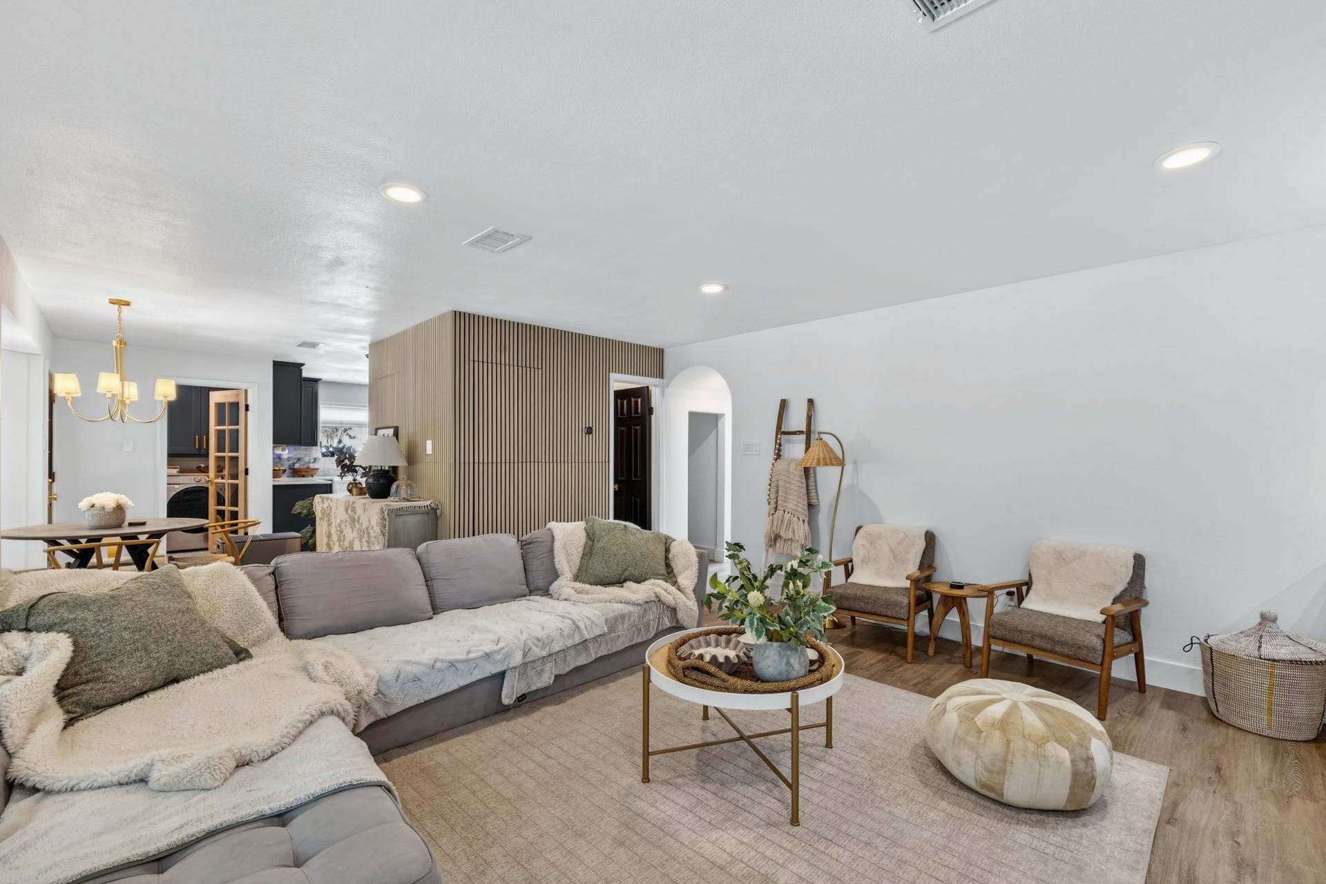 129 N Rainbow Ridge Circle, The Woodlands, TX 77381 Custom wall detailing adds texture and depth to the living room design