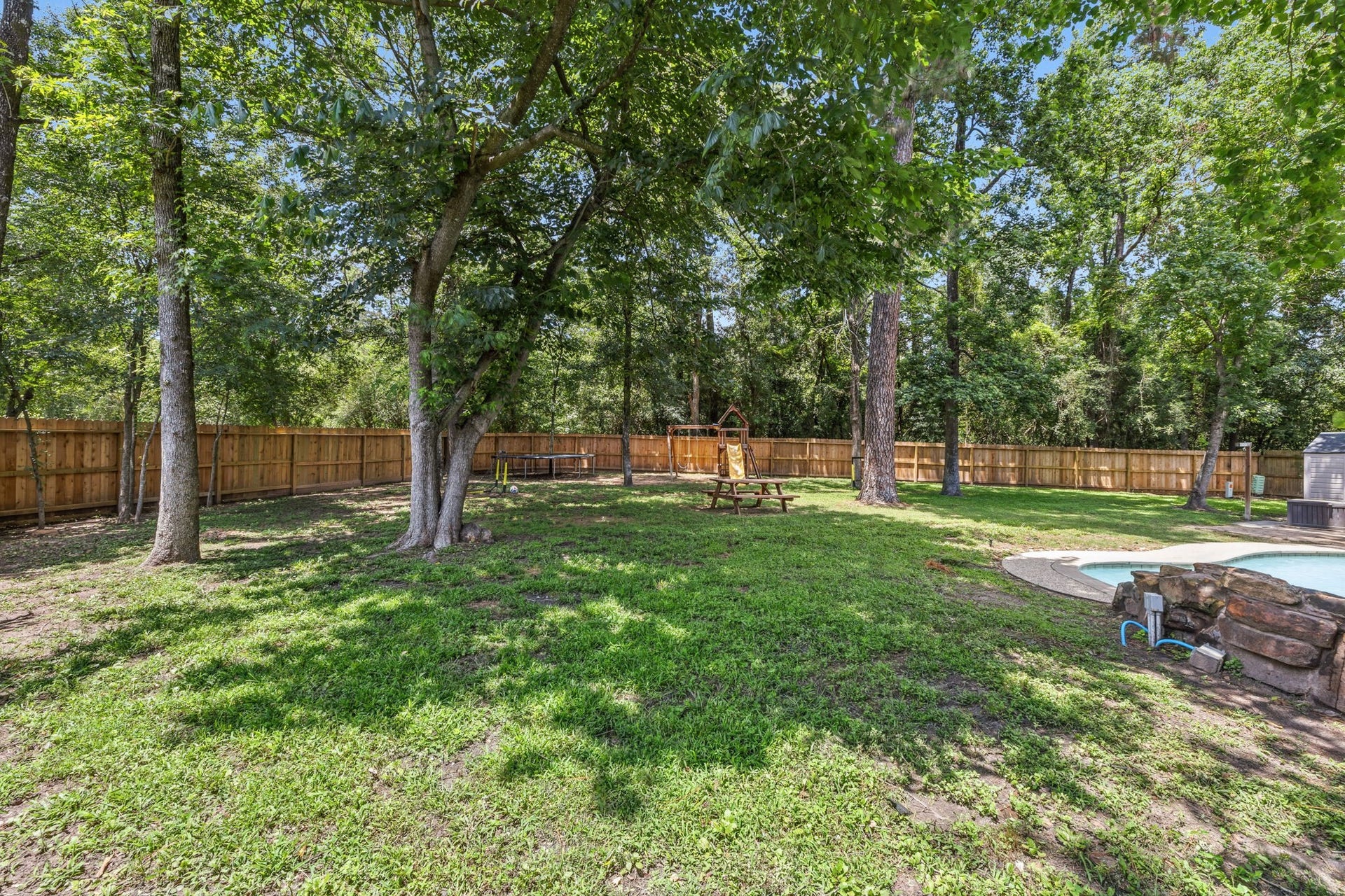 129 N Rainbow Ridge Circle, The Woodlands, TX 77381 Set on an expansive 14,000+ sqft lot with room to gather, play, and entertain