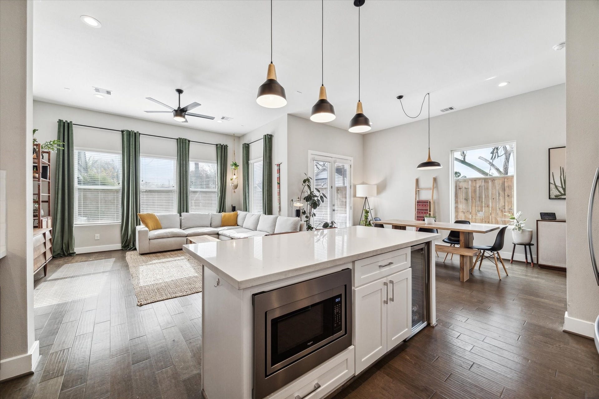 Oversized kitchen island with wine fridge and microwave discreetly tucked away to save on counter top space.