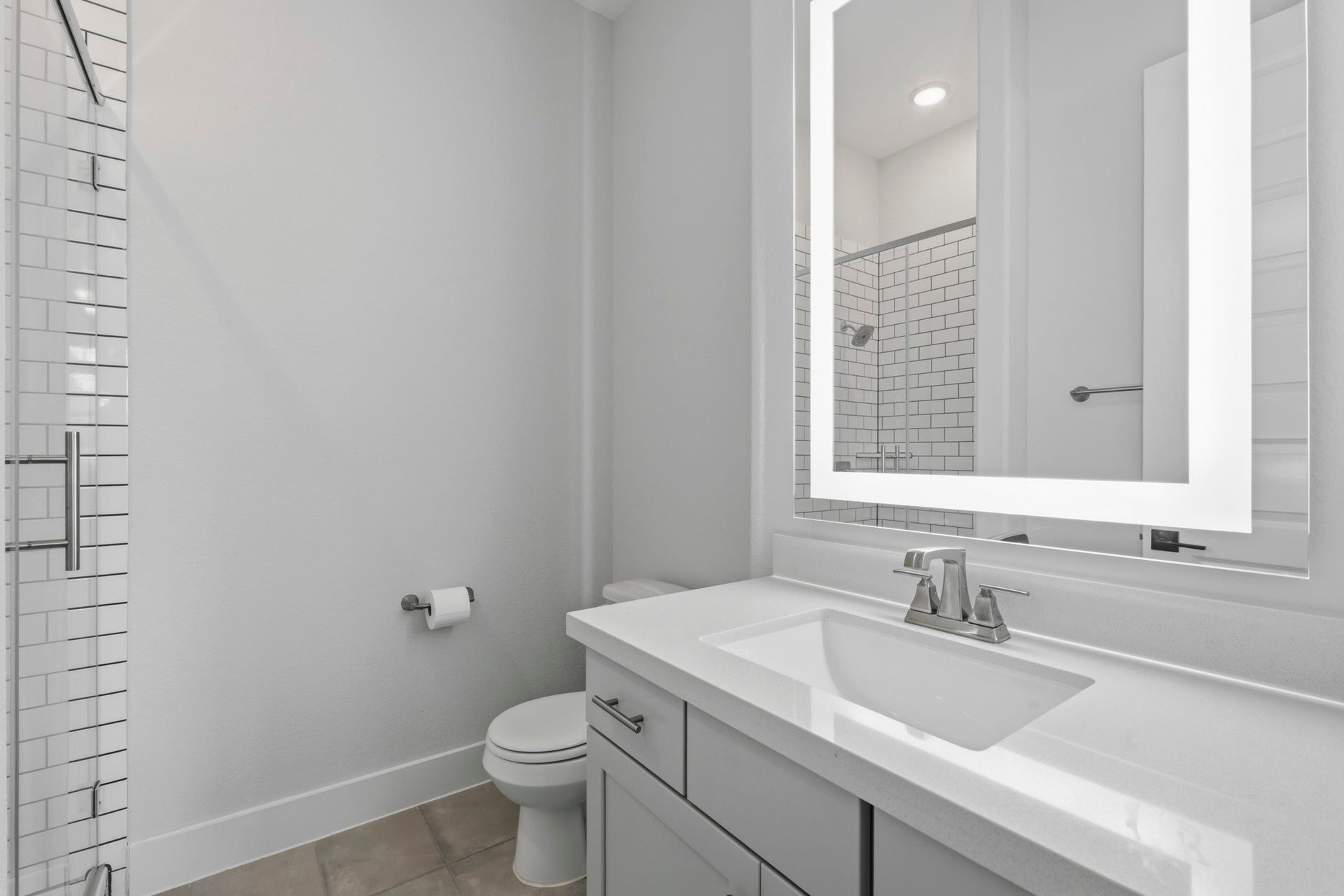 9907 Regal Bend Drive, Missouri City, TX 77459 First floor guest room suite bathroom, LED mirror, subway tile and shower