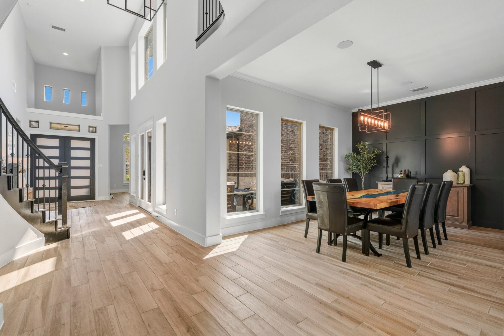 9907 Regal Bend Drive, Missouri City, TX 77459 Dining room with board and batten accent wall, speakers and modern 8 candle LED light fixture