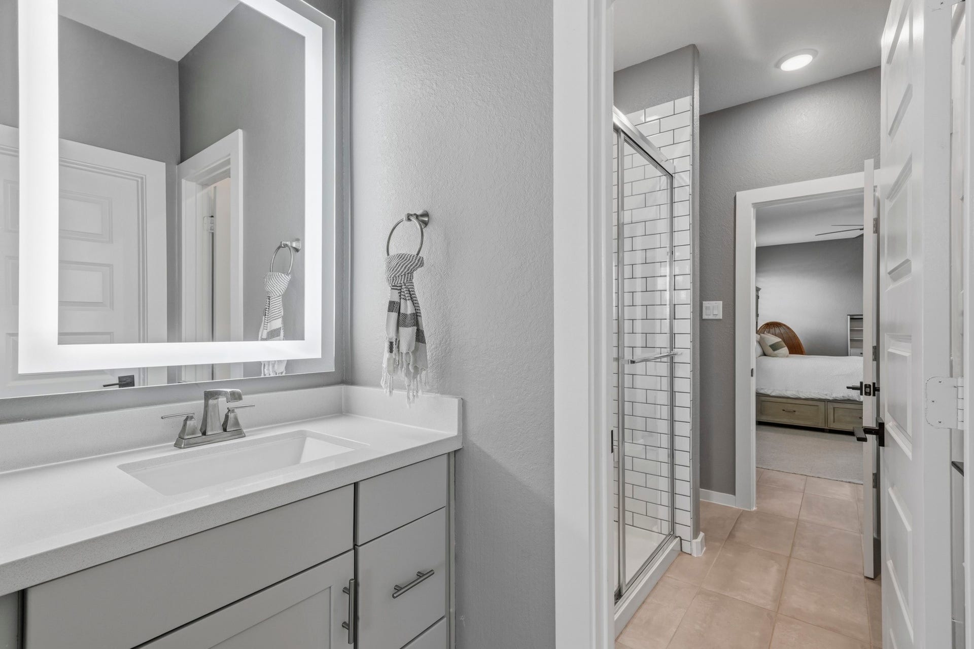 9907 Regal Bend Drive, Missouri City, TX 77459 Jack & Jill bathroom with an upgraded shower, tile and 2 LED mirrors.