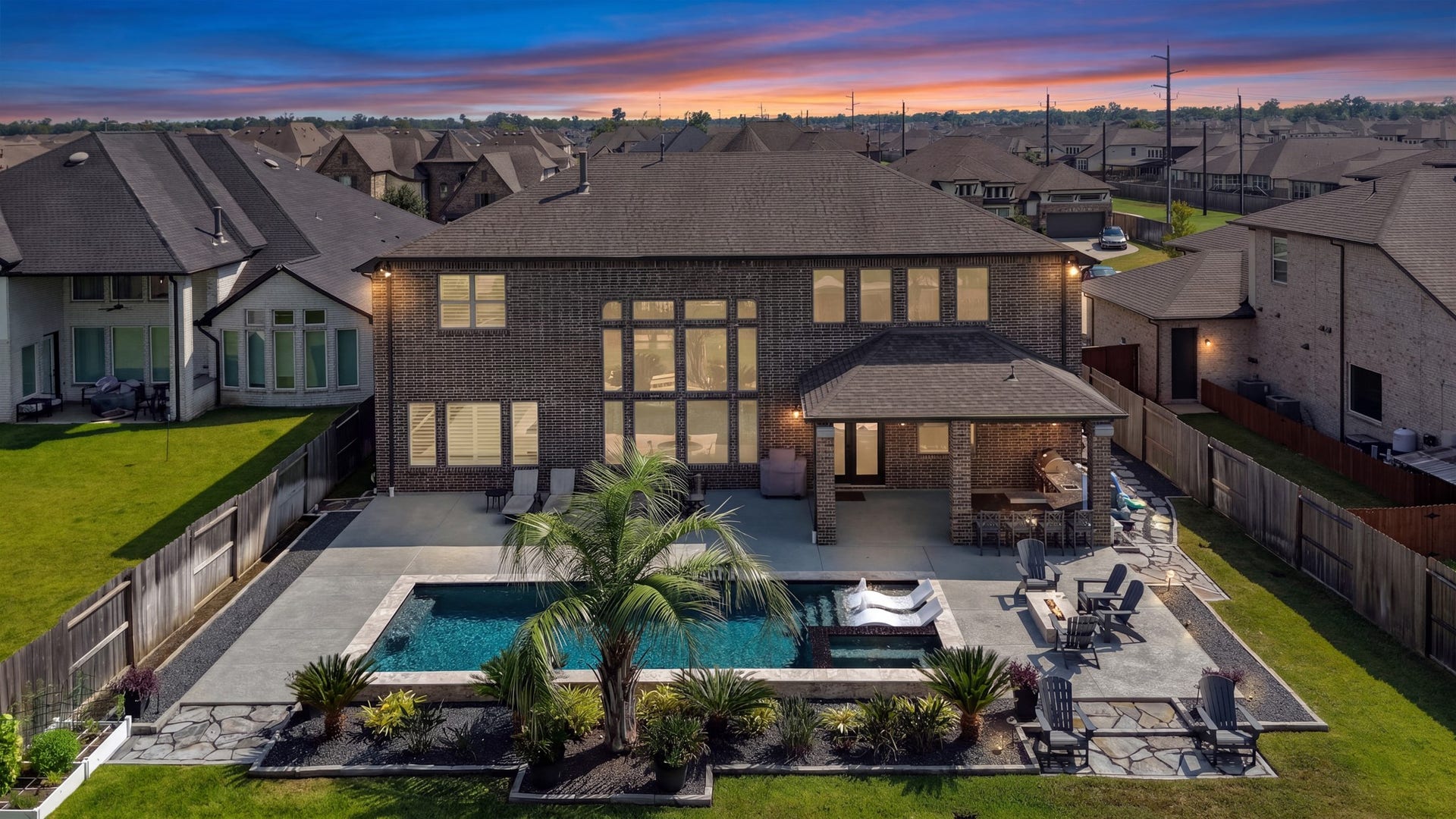 9907 Regal Bend Drive, Missouri City, TX 77459 Great shot of the backyard, Outdoor kitchen, Pool (salt & UV pebble finish) Autofill, Floor circulation system, Heater, LED lighting, 3 waterfalls, 2 Bubblers, tanning deck with 2 loungers & attached spa! Firepit for cool nights