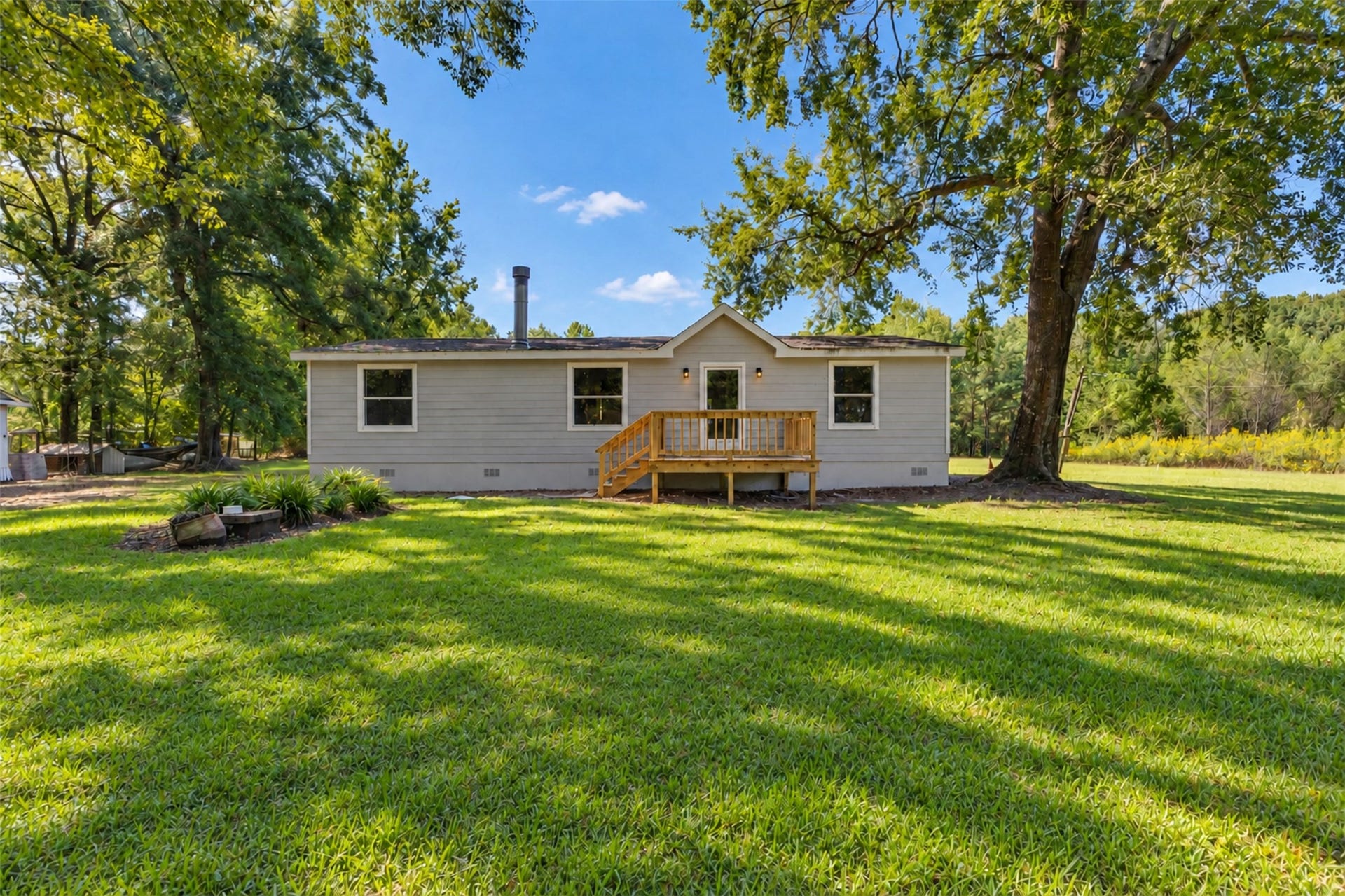 2009 Holder Rambo Road, Huffman, TX 77336 Charming single-story home set on a spacious, lush green lot, surrounded by mature trees offering tranquility and privacy.