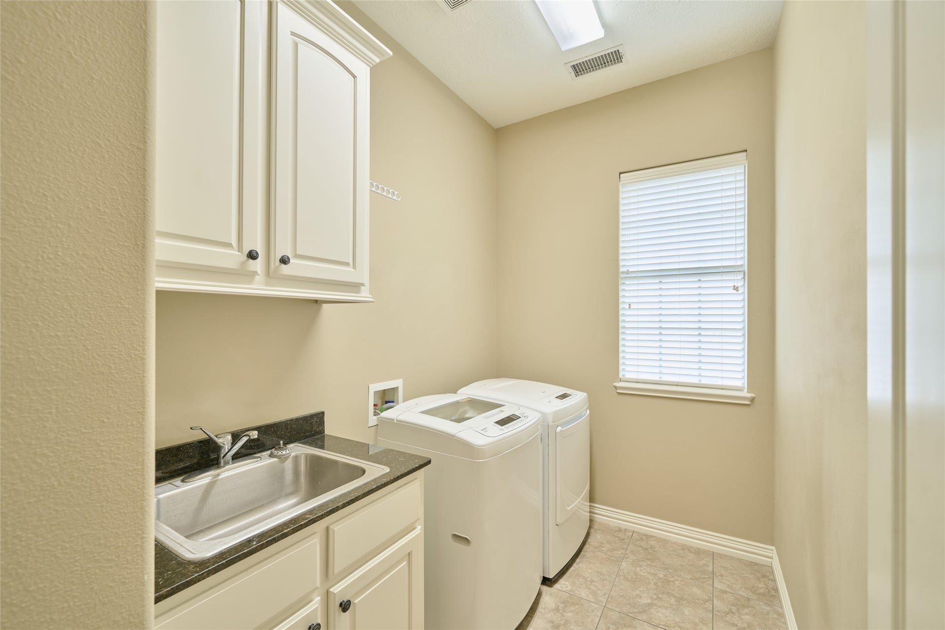 11130 Hunters Landing, Montgomery, TX 77356 Utility Room is inside with a separate sink and storage cabinets.