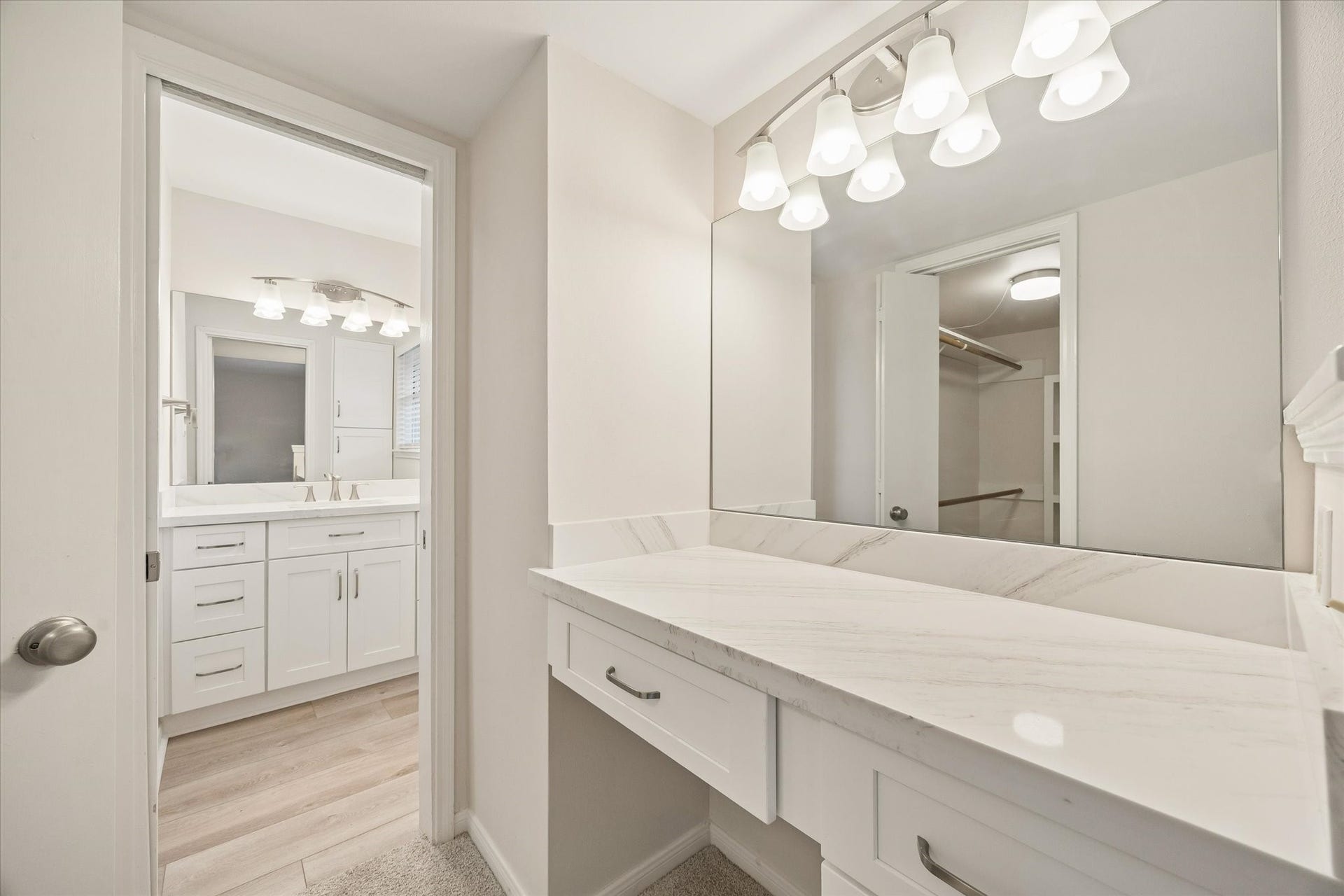 114 CAMELLIA STREET, Sugar Land, TX 77478 THE PRIMARY BATH INCLUDES A DEDICATED VANITY AREA WITH STONE COUNTERTOPS, AMPLE STORAGE, AND A LARGE WALL MIRROR.