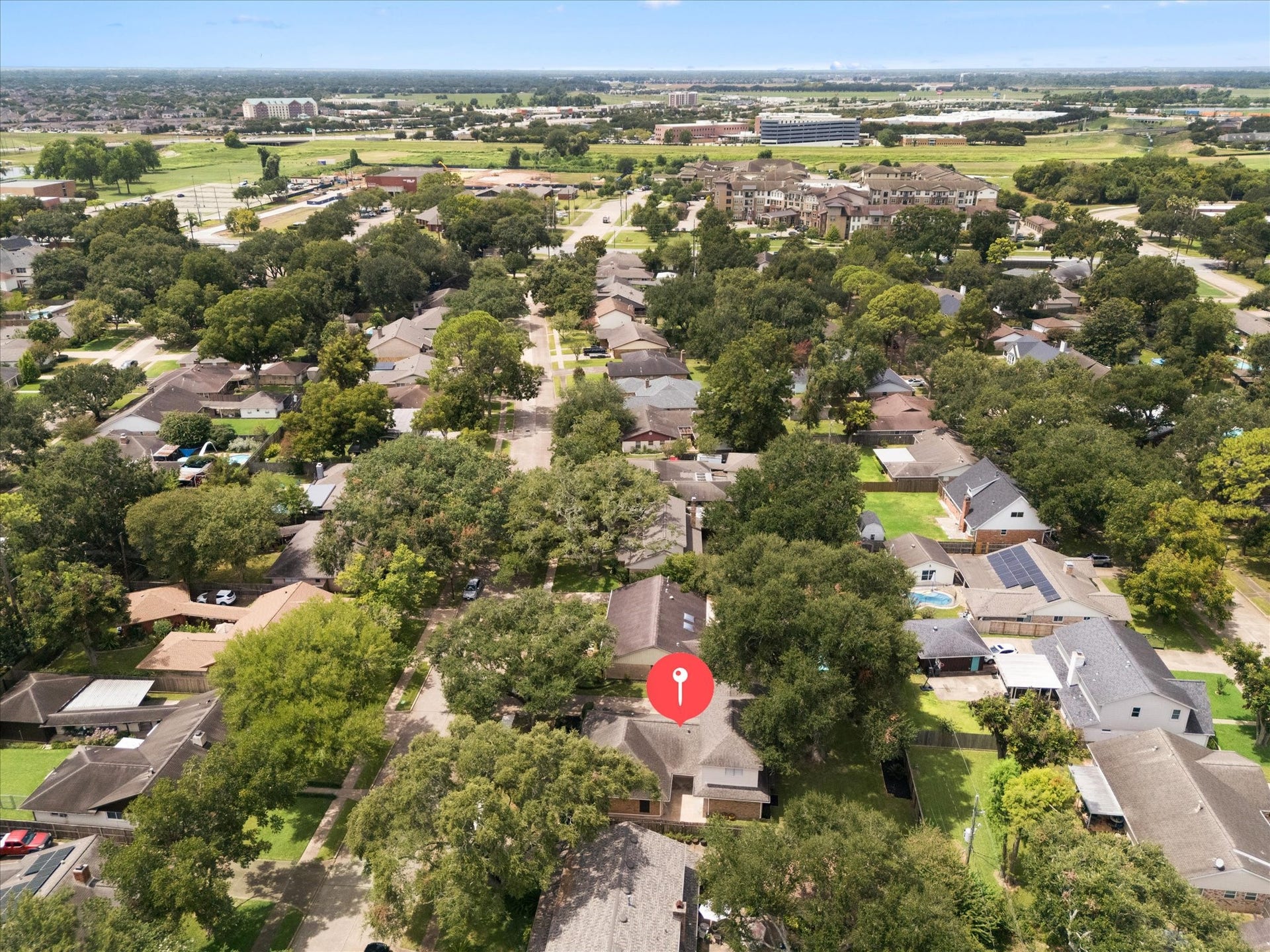 114 CAMELLIA STREET, Sugar Land, TX 77478 THE SPACIOUS BACKYARD OFFERS A LARGE LAWN, MATURE SHADE TREES, AND PLENTY OF ROOM FOR OUTDOOR LIVING OR PLAY.